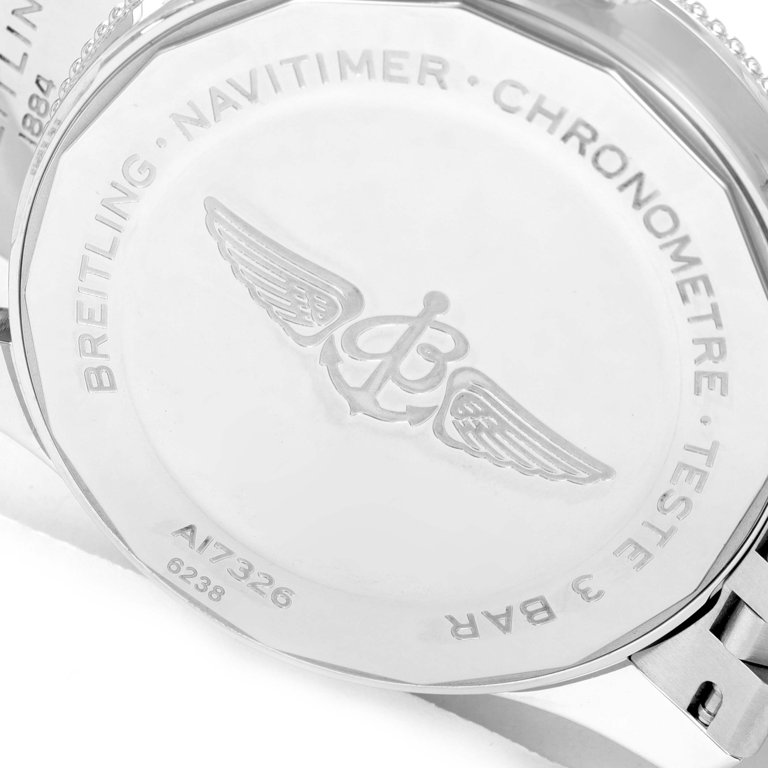 The image shows the back case of a Breitling Navitimer A17326 Men's Stainless Steel Black Dial A17326 Men's Stainless Steel Black Dial watch, highlighting the engravings and logo.