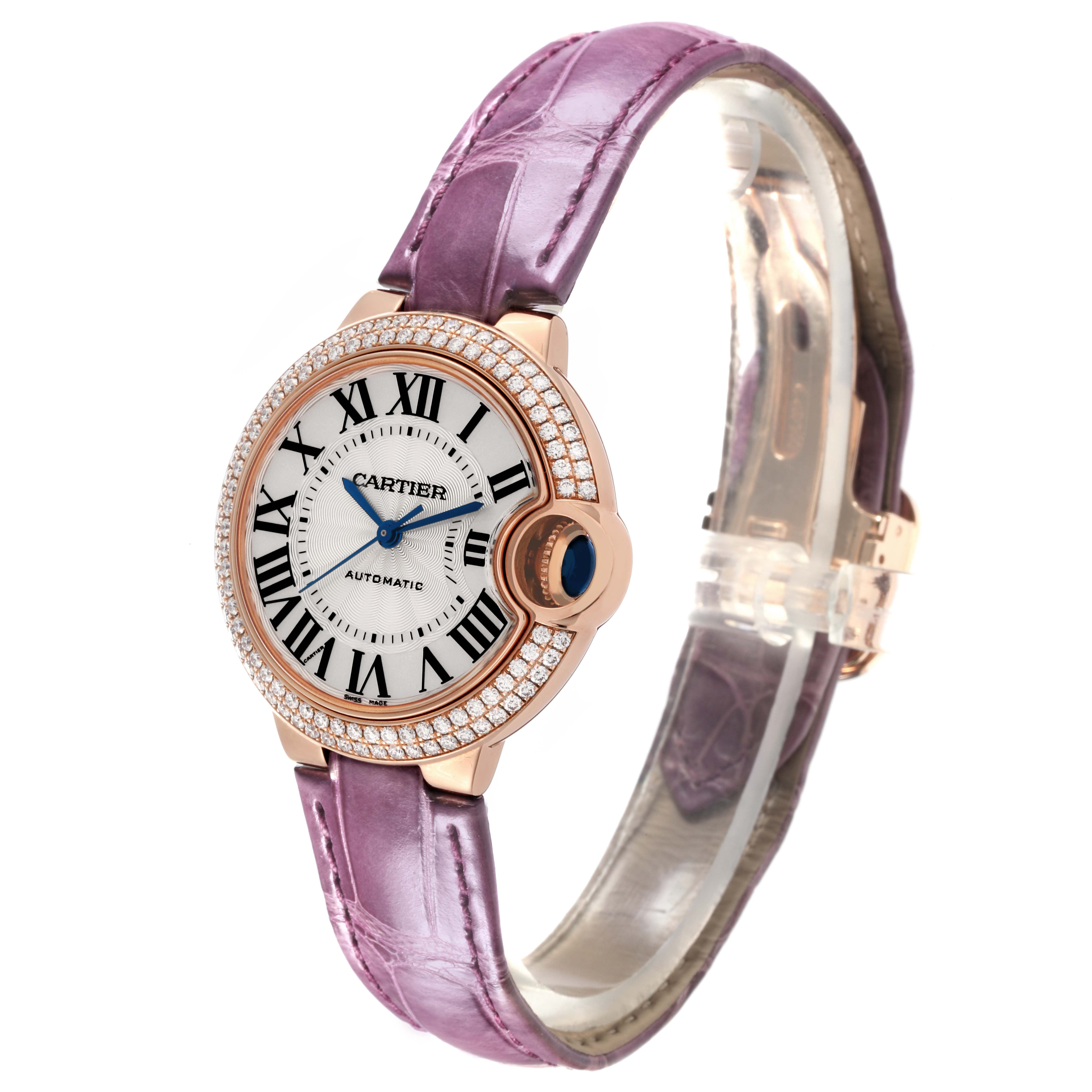 The Cartier Ballon Bleu WE902066 Women's Rose Gold Silver Dial WE902066 Women's Rose Gold Silver Dial watch is shown at a three-quarter angle, highlighting the face, bezel, and lavender strap.