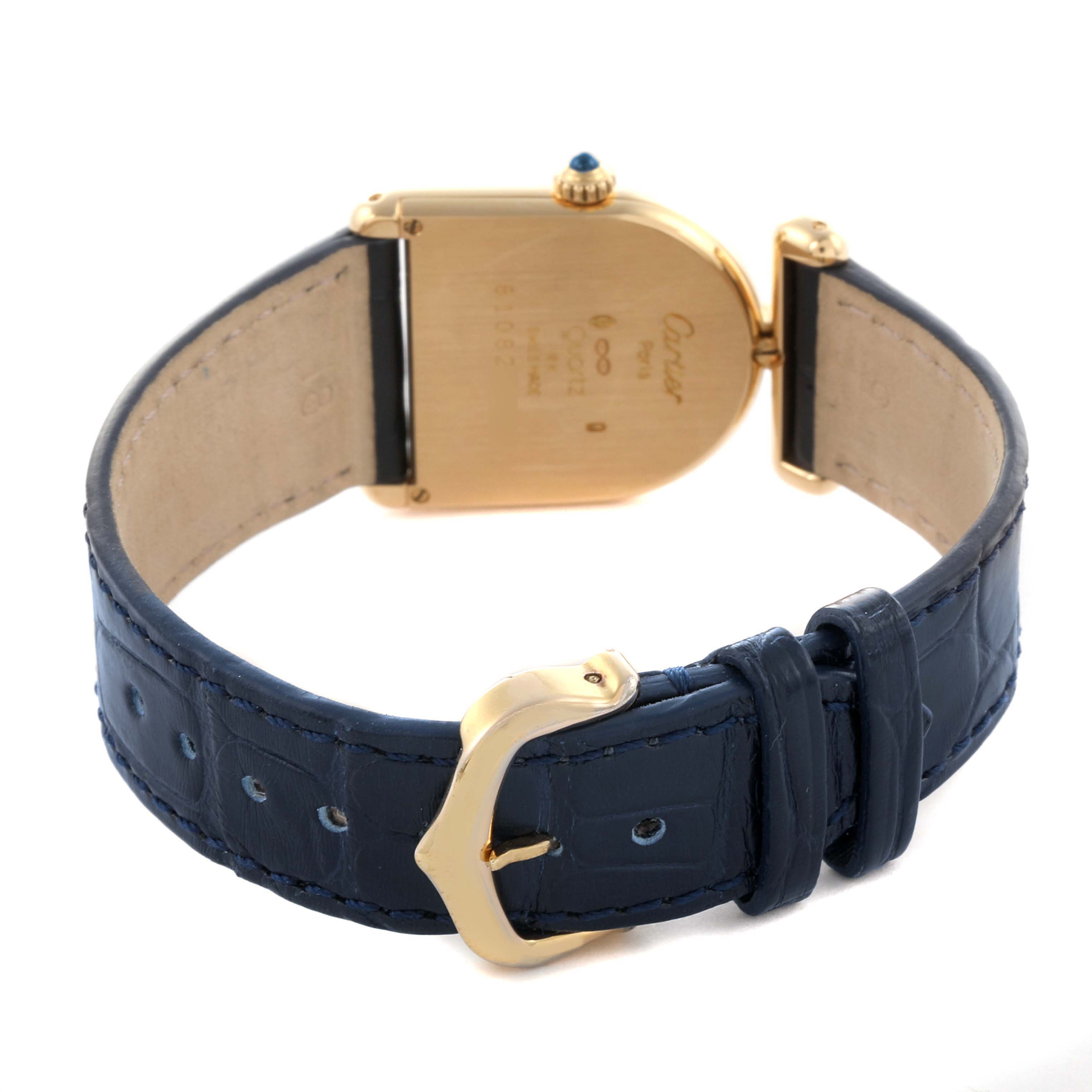 The image shows the back view of the Cartier Cloche Calandre 81082 Women
s Yellow Gold Silver Dial 81082 Women
s Yellow Gold Silver Dial, highlighting its blue leather strap and gold buckle.