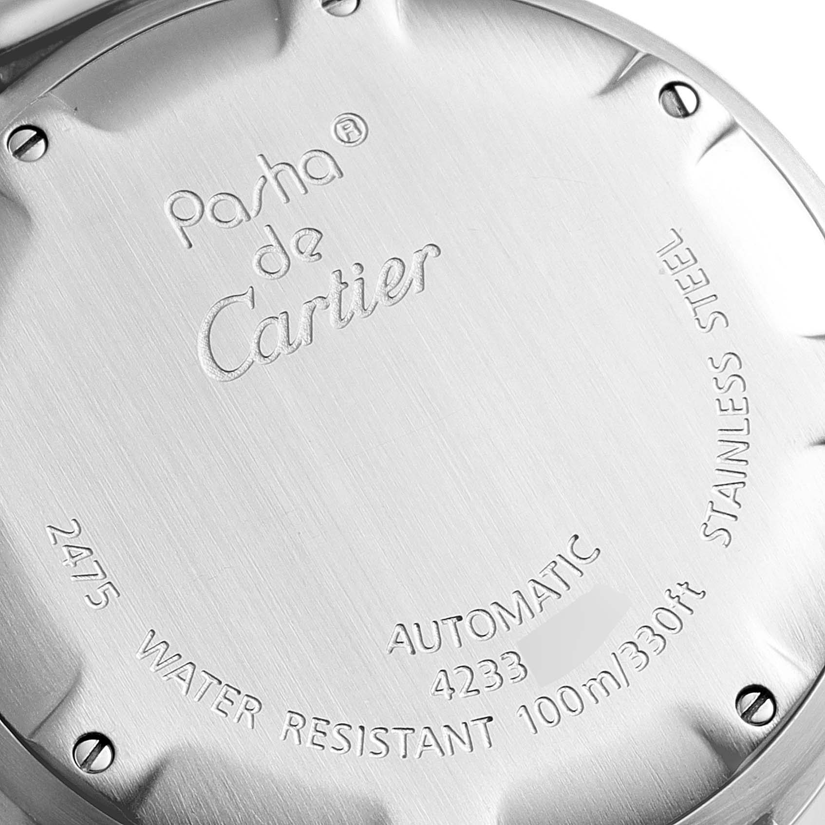 This image shows the engraved case back of a Pasha de Cartier watch, highlighting branding and specifications.