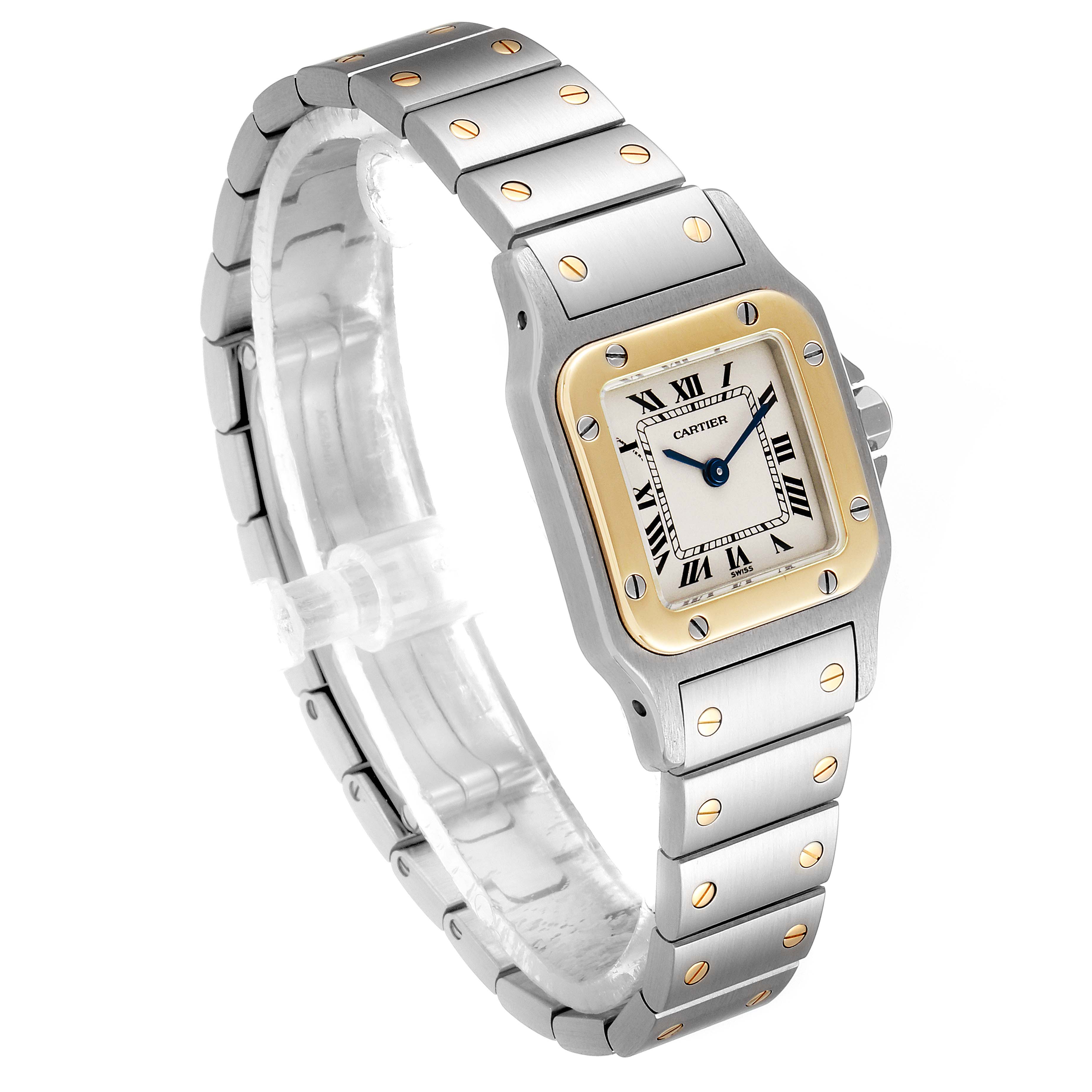 The image shows a Cartier Santos W20012C4 Women
s Steel and Gold (two tone) Silver Dial W20012C4 Women
s Steel and Gold (two tone) Silver Dial watch from an angled front view, displaying the face, bezel, and bracelet with screws.