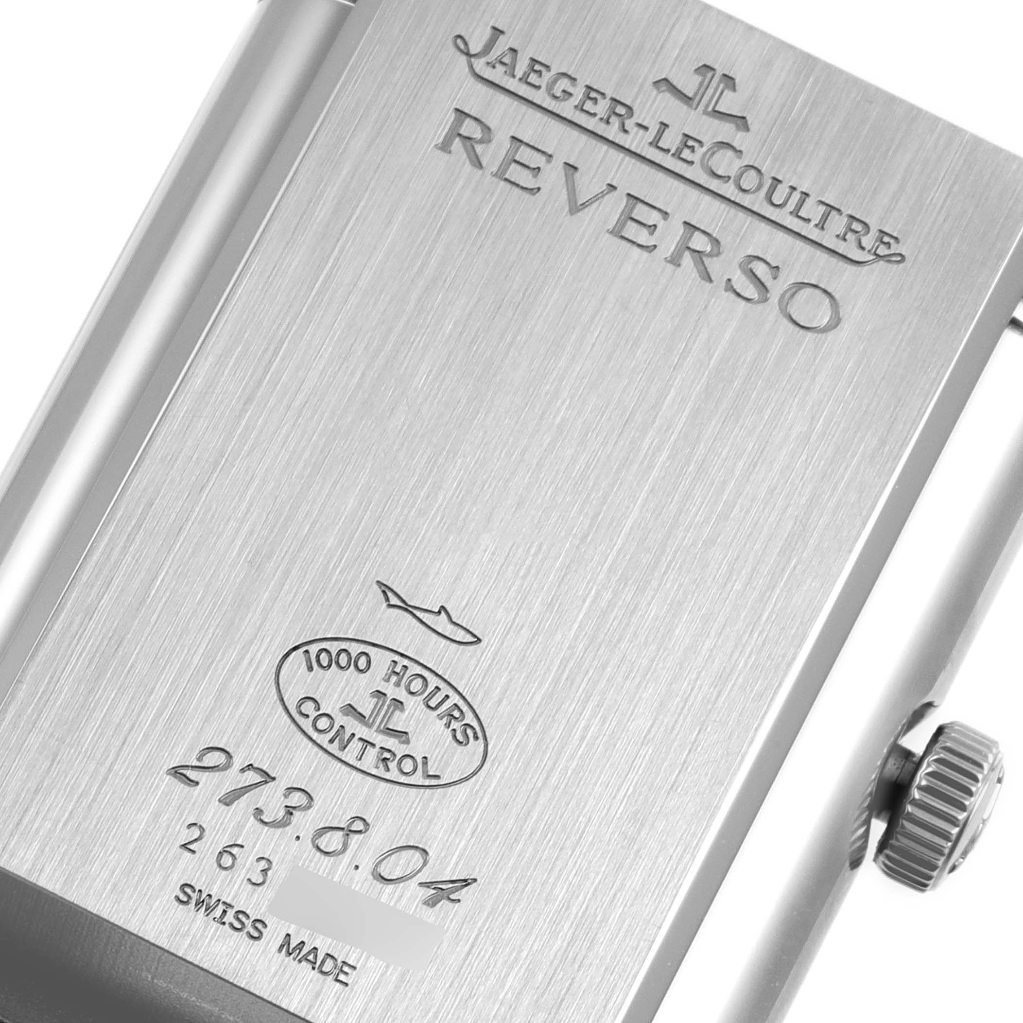 The image shows the polished back case and crown of a Jaeger-LeCoultre Reverso watch.