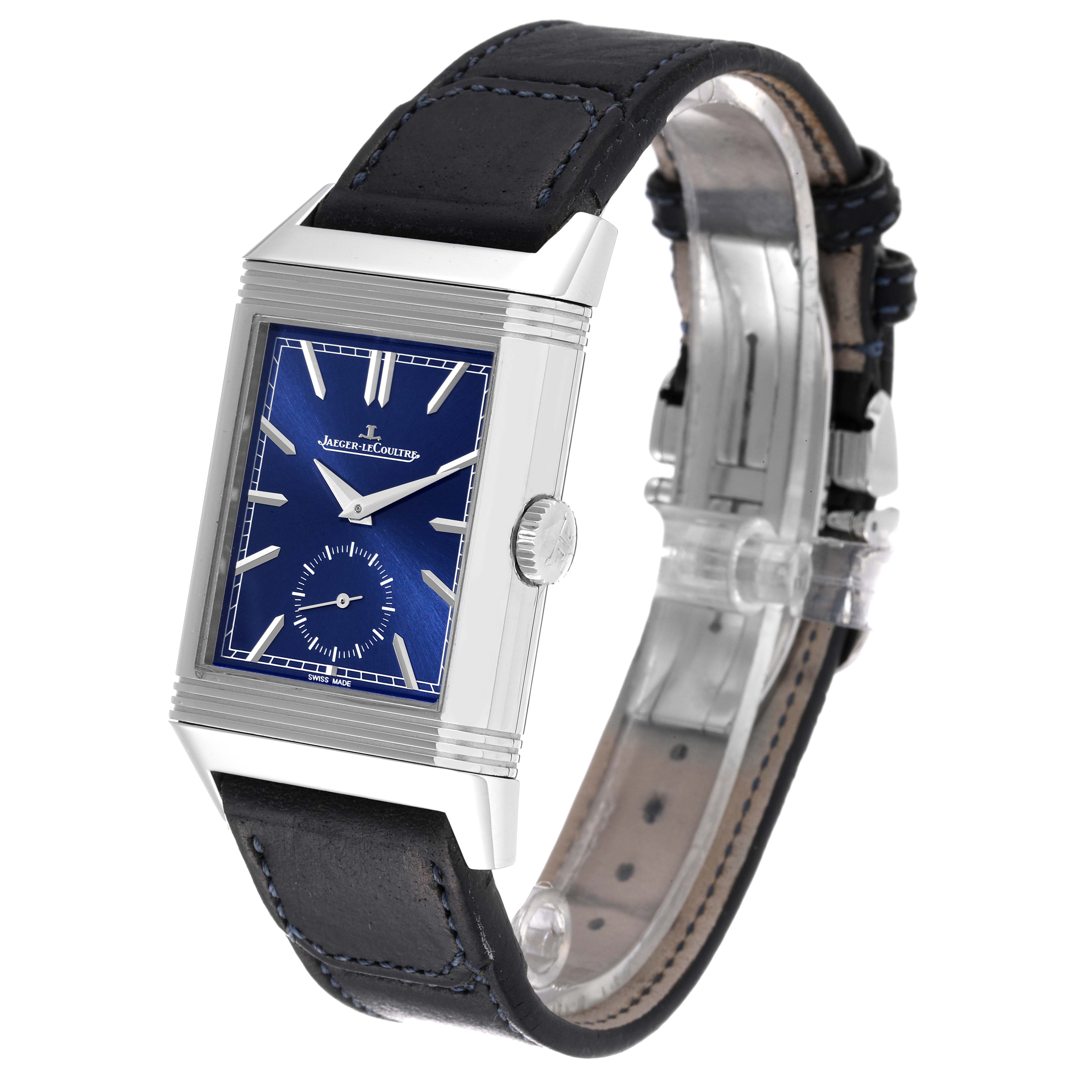 The Jaeger-LeCoultre Reverso watch is shown at an oblique angle, highlighting its rectangular case, blue dial, and black strap.