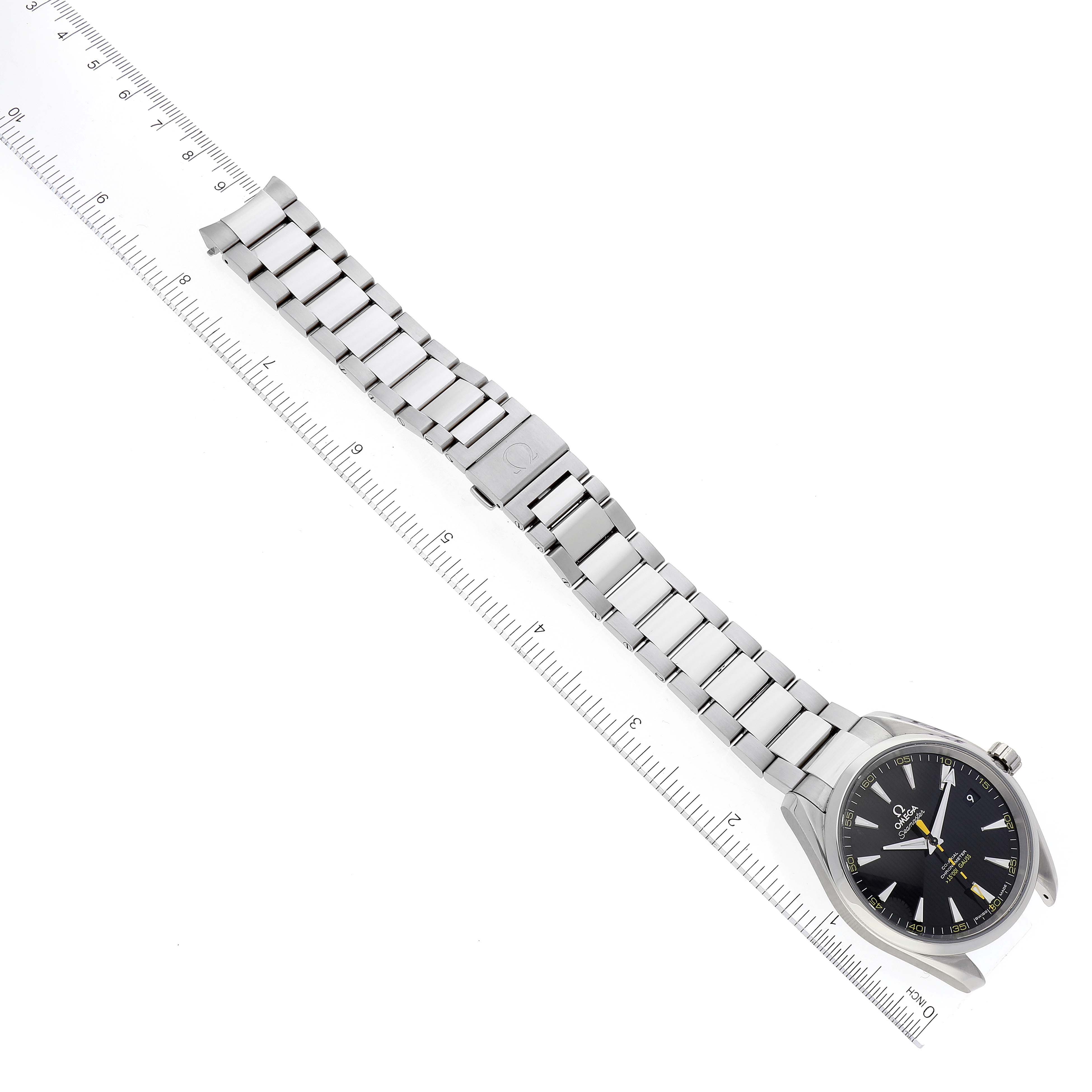 The Omega Aqua Terra 231.10.42.21.01.002 Men's Stainless Steel Black Dial 231.10.42.21.01.002 Men's Stainless Steel Black Dial watch is displayed flat, showing its entire bracelet and clasp alongside a measuring ruler.