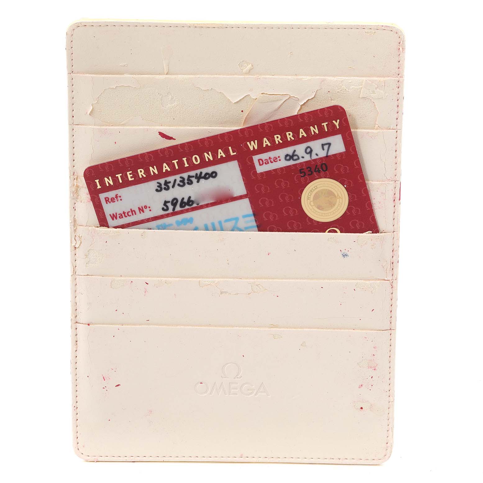 The image shows an Omega Speedmaster 3513.54.00 Men's Stainless Steel Black Dial 3513.54.00 Men's Stainless Steel Black Dial's International Warranty card in a white, branded cardholder from a top-down angle.