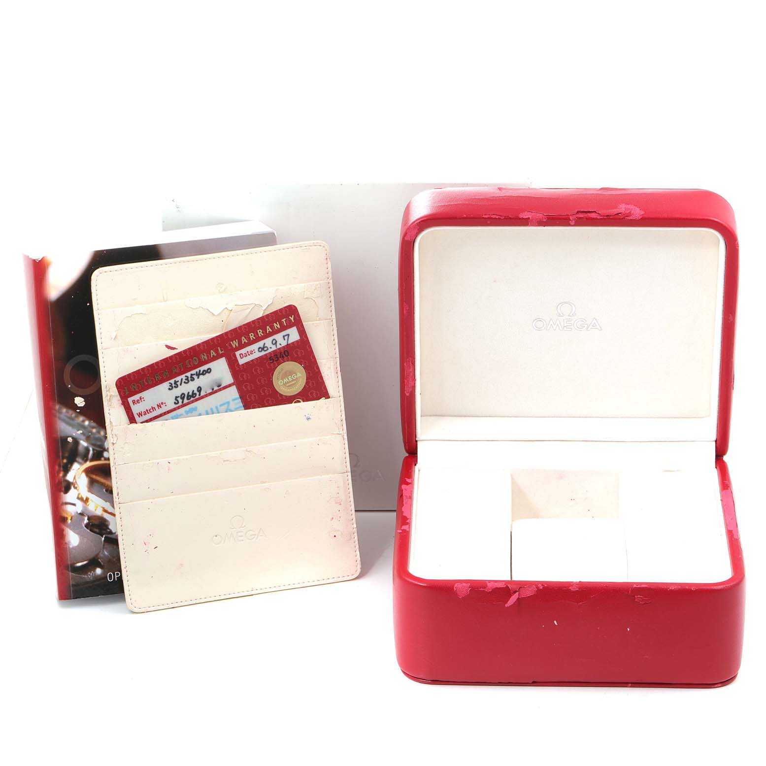 The image shows a red Omega Speedmaster 3513.54.00 Men's Stainless Steel Black Dial 3513.54.00 Men's Stainless Steel Black Dial watch box, warranty cards, and a cardholder.