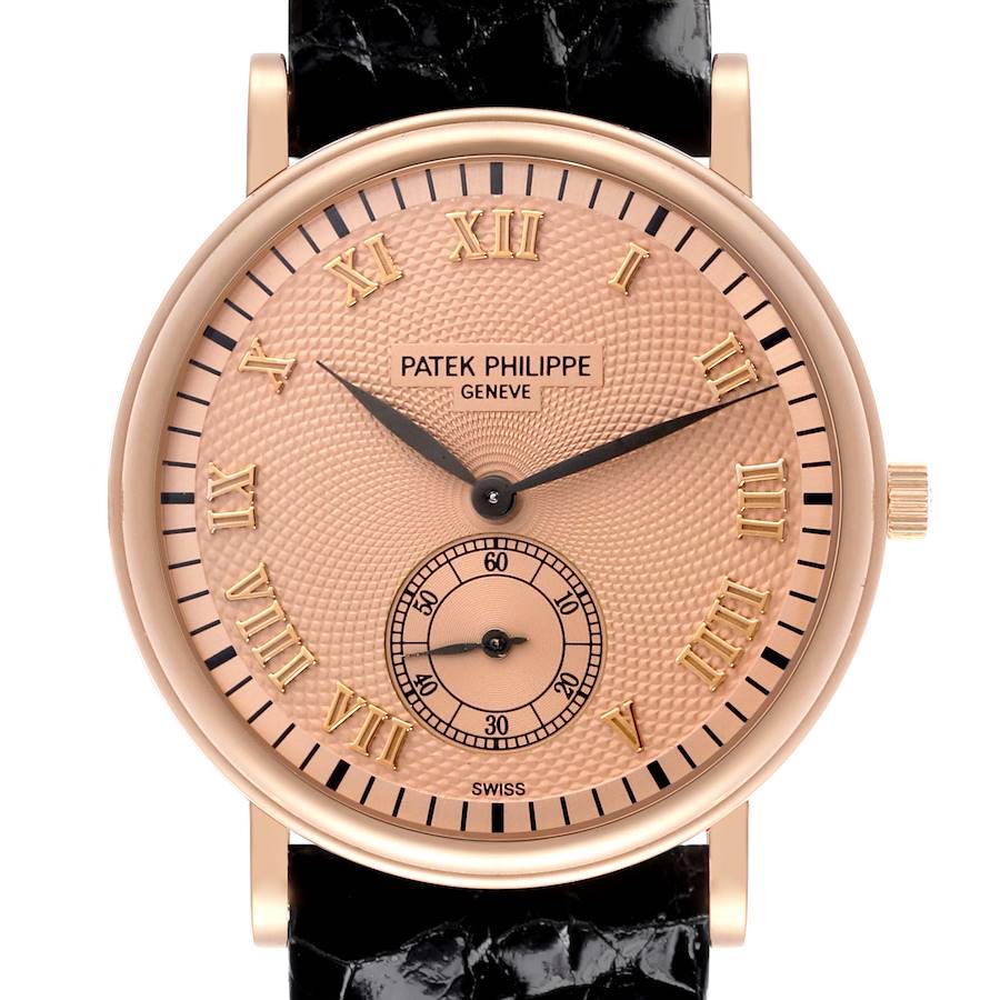 The Patek Philippe Calatrava watch is shown from the front, showcasing its dial, Roman numerals, and leather strap.