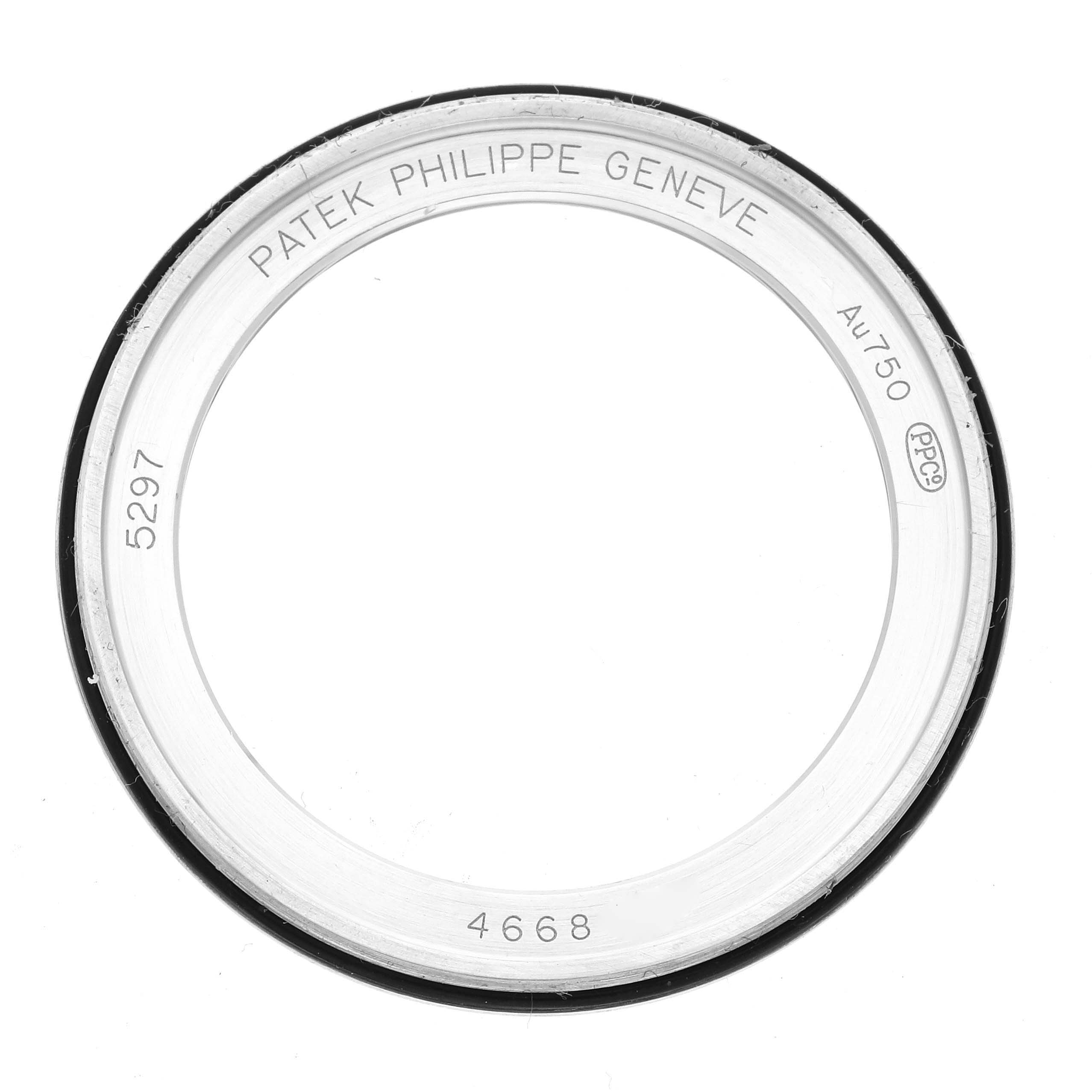 The image shows a top-down view of a bezel from the Patek Philippe Calatrava 5297G-001 Men's White Gold Black Dial 5297G-001 Men's White Gold Black Dial model, displaying engravings.