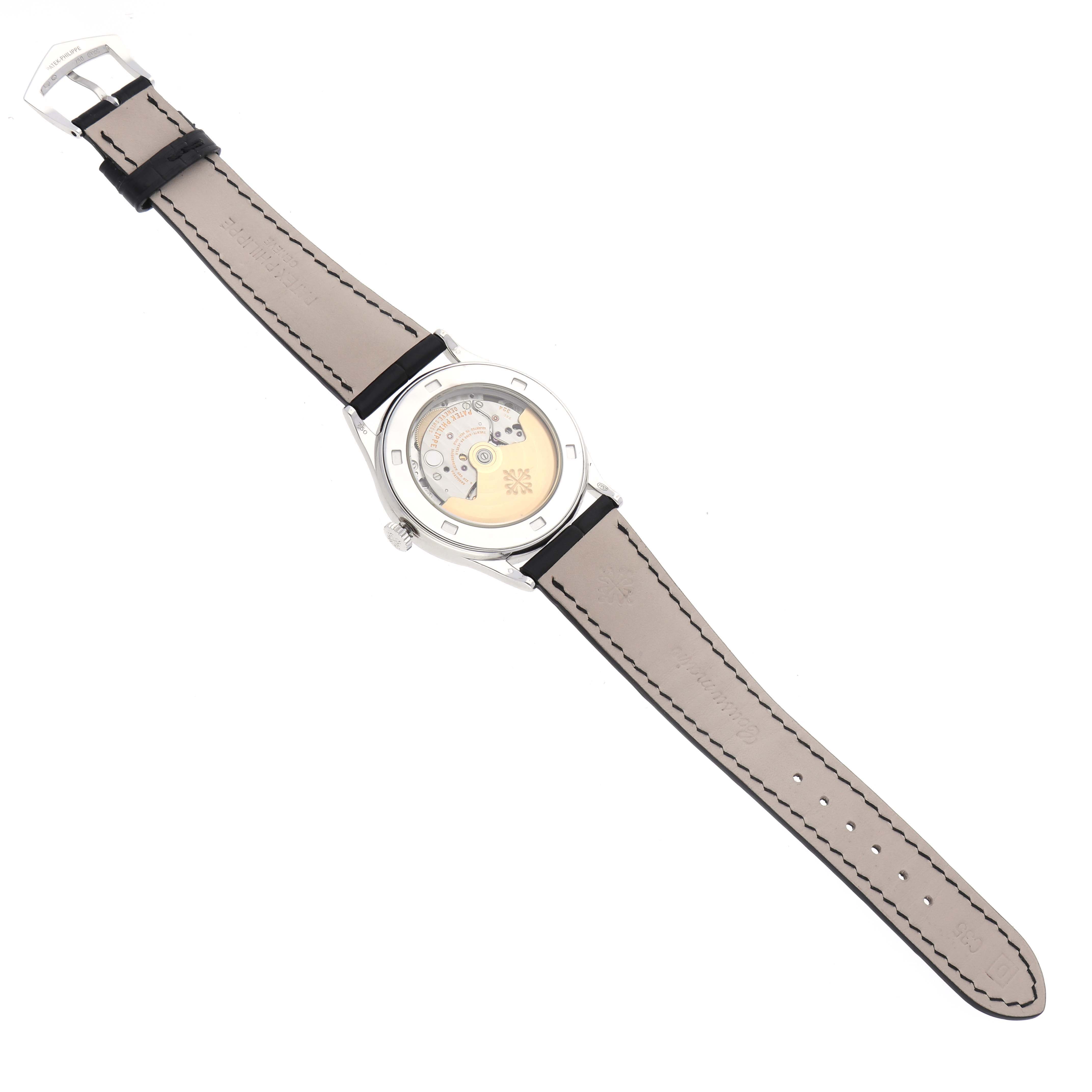 The Patek Philippe Calatrava 5297G-001 Men's White Gold Black Dial 5297G-001 Men's White Gold Black Dial watch is shown from the back, highlighting the transparent case and movement.