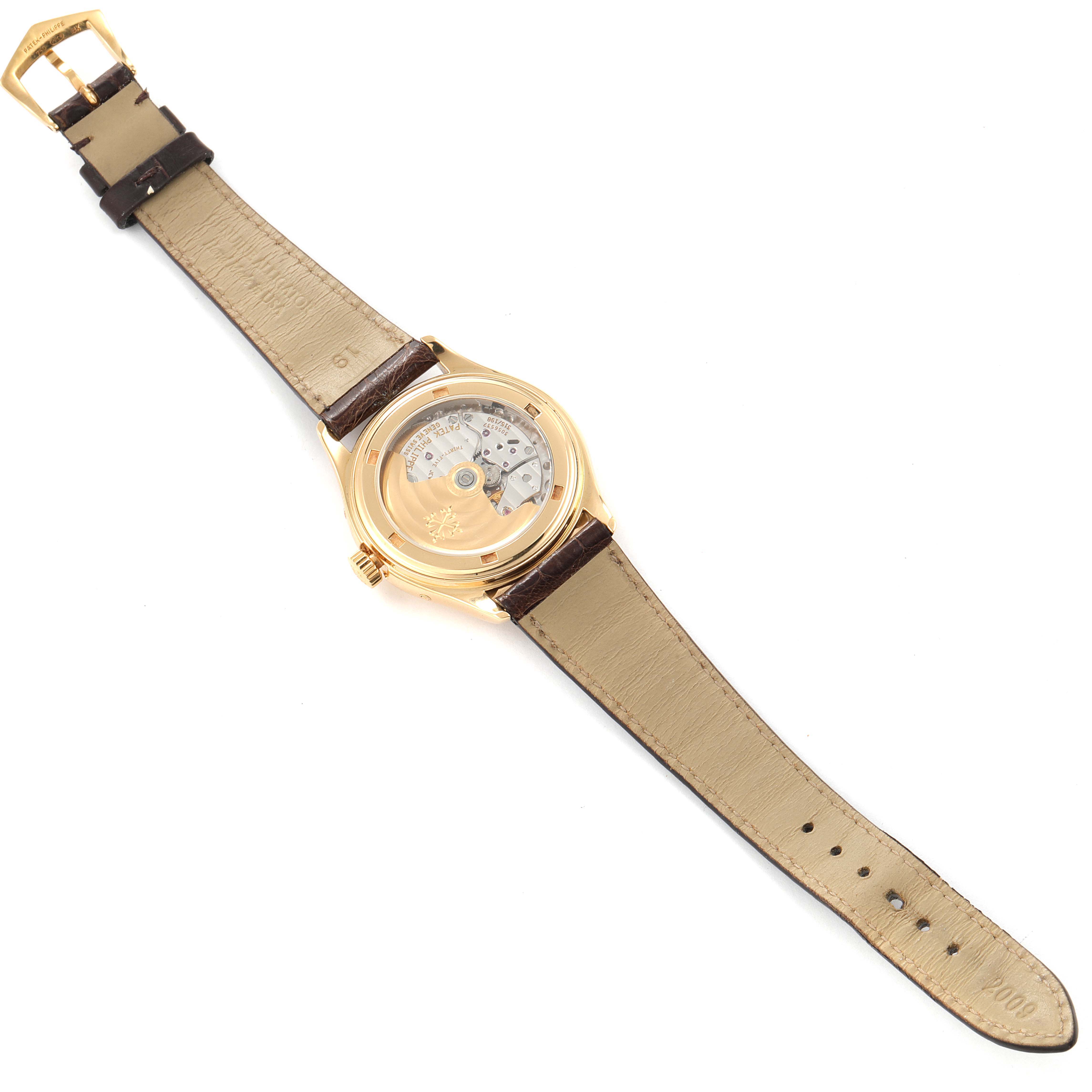 The image shows the back view of a Patek Philippe Complications 5035G Men's Yellow Gold Silver Dial 5035G Men's Yellow Gold Silver Dial model watch, revealing the movement and leather strap.