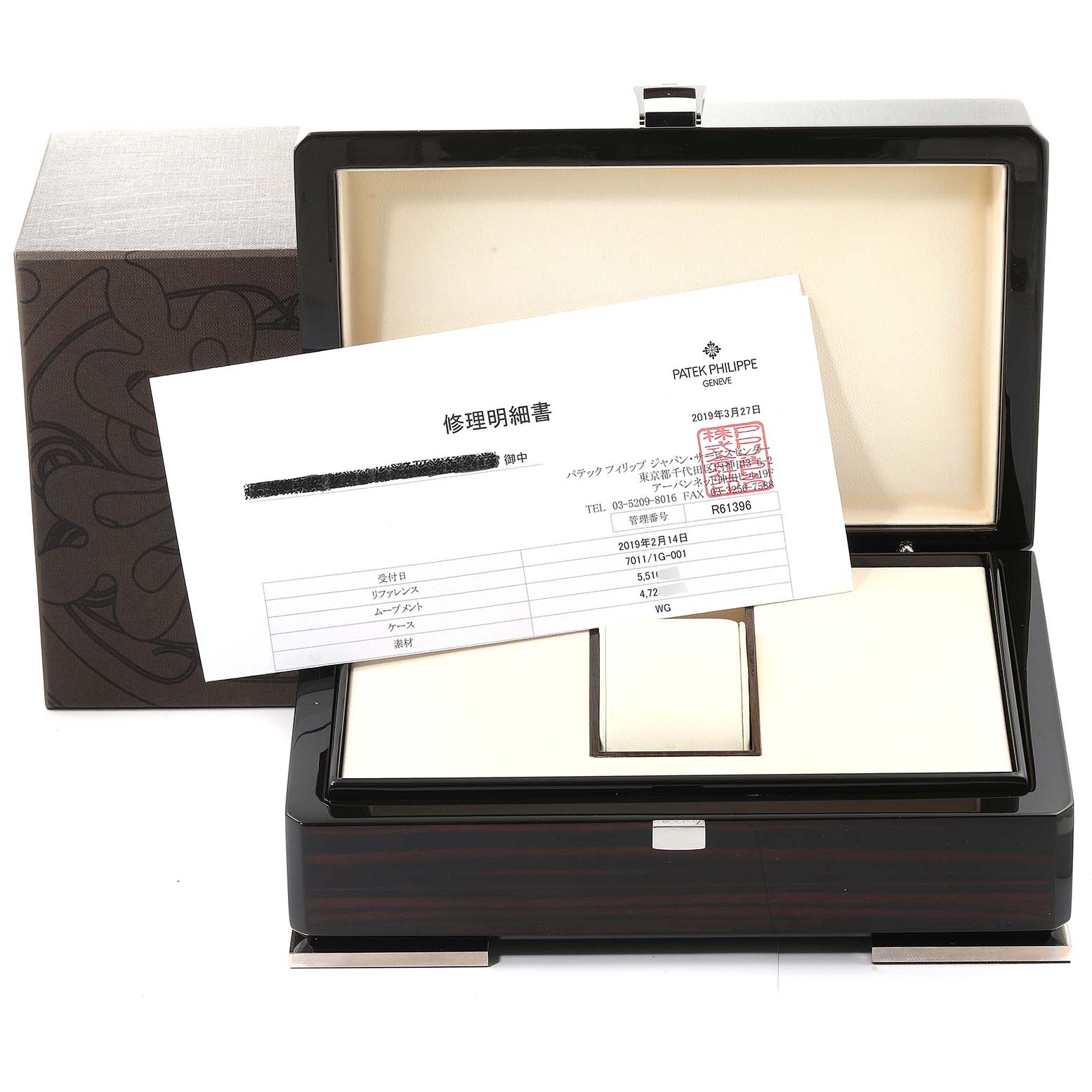 The image shows an open box for a Patek Philippe Nautilus 7011/1G-001 Women's White Gold Silver Dial 7011/1G-001 Women's White Gold Silver Dial watch, with documentation placed on top.