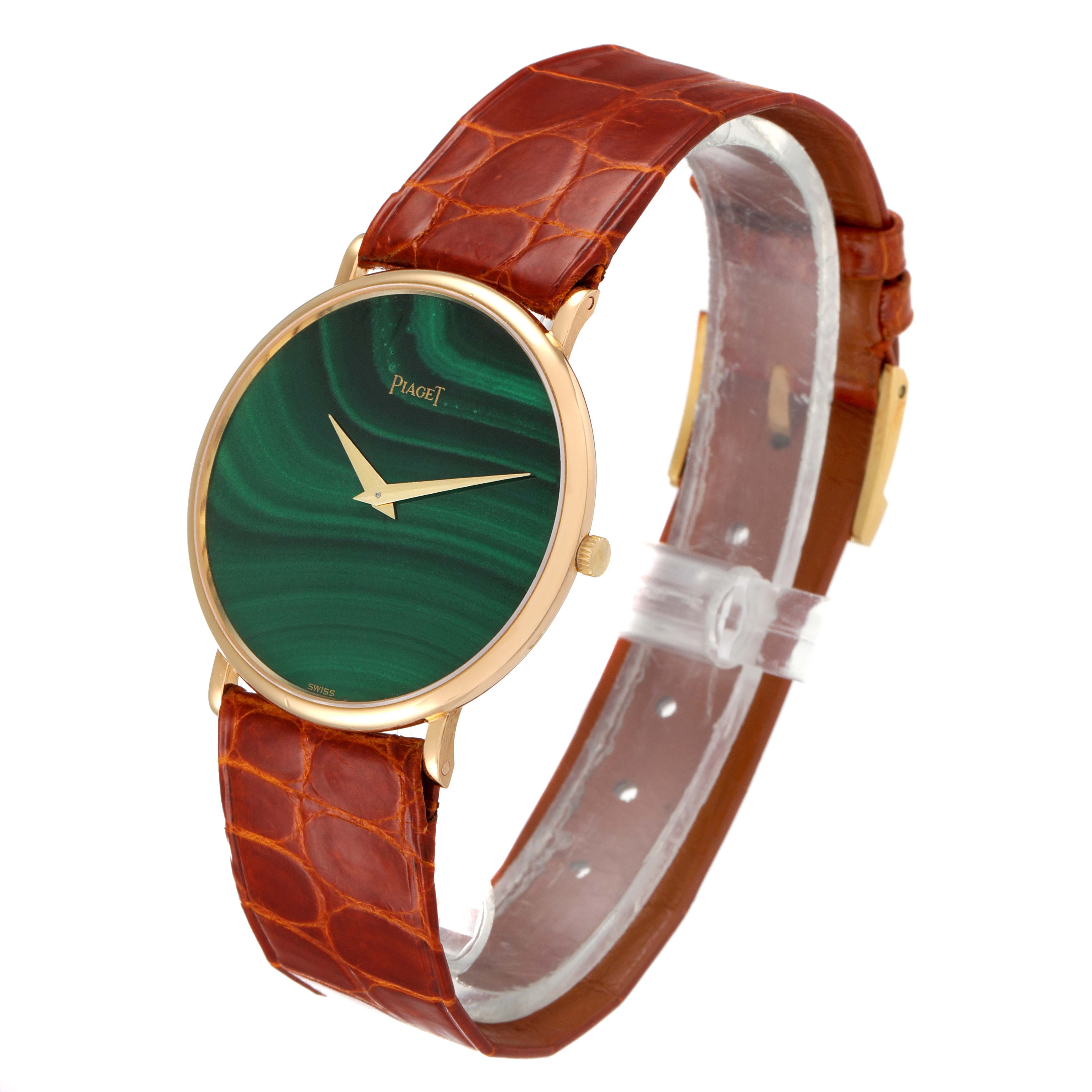 This Piaget 9035 Men
s Yellow Gold Green Dial 9035 Men
s Yellow Gold Green Dial 9035 model watch is shown at a slight angle, highlighting the yellow gold malachite stone dial and brown leather strap.