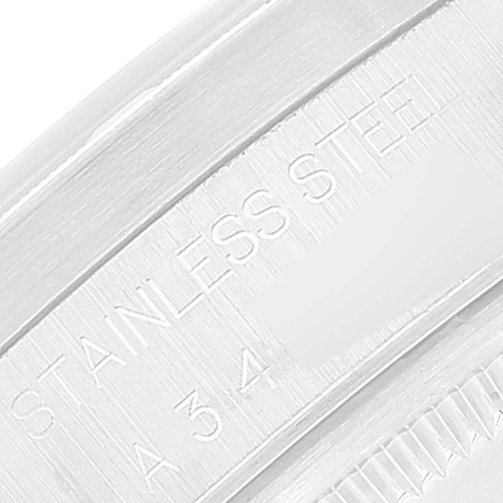 This close-up image shows the engraving of "STAINLESS STEEL" and a part of the serial number on the edge of a Rolex Air-King 14010 Men's Stainless Steel Black Dial 14010 Men's Stainless Steel Black Dial watch case.