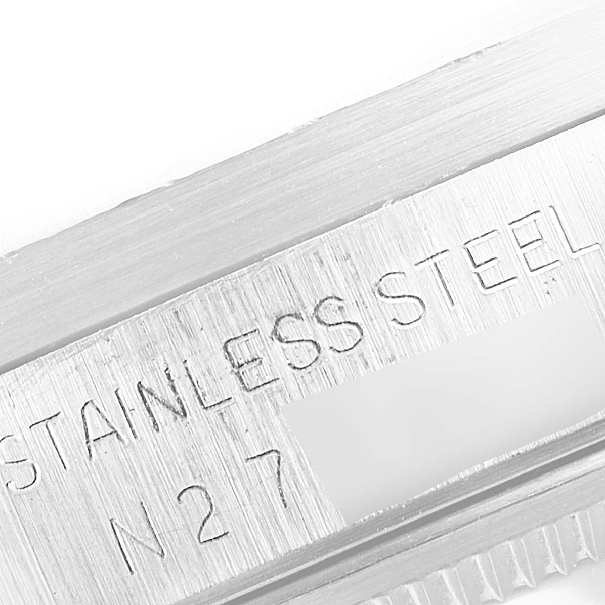 This close-up image shows the "STAINLESS STEEL" engraving on the side of the Rolex Air-King 14010 Men's Stainless Steel Blue Dial 14010 Men's Stainless Steel Blue Dial watch case.