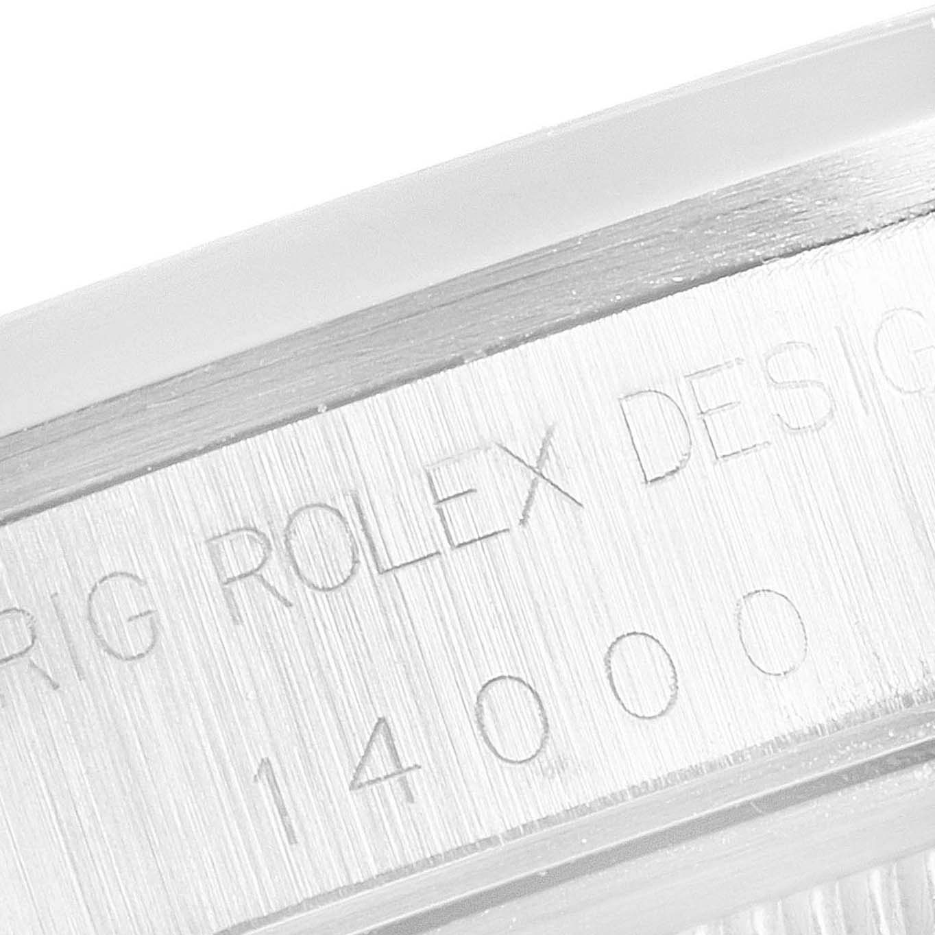 This close-up image shows the engraved side of the bezel of a Rolex Air-King 14000 Men's Stainless Steel Silver Dial 14000 Men's Stainless Steel Silver Dial watch with design and model information.