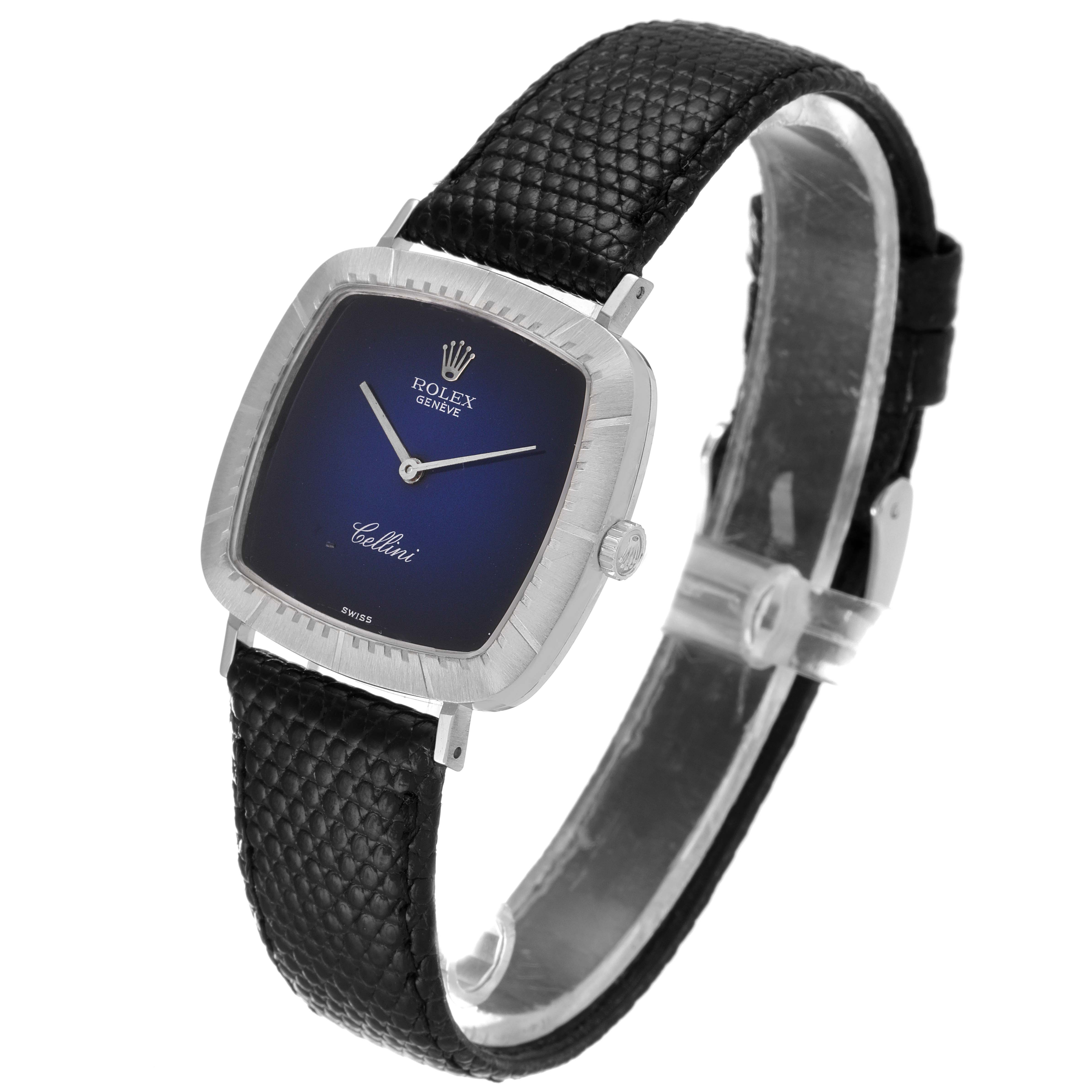The Rolex Cellini 4084 Women's White Gold Blue Dial 4084 Women's White Gold Blue Dial watch is shown at a slight angle, featuring a blue dial, silver case, and a black textured leather strap.