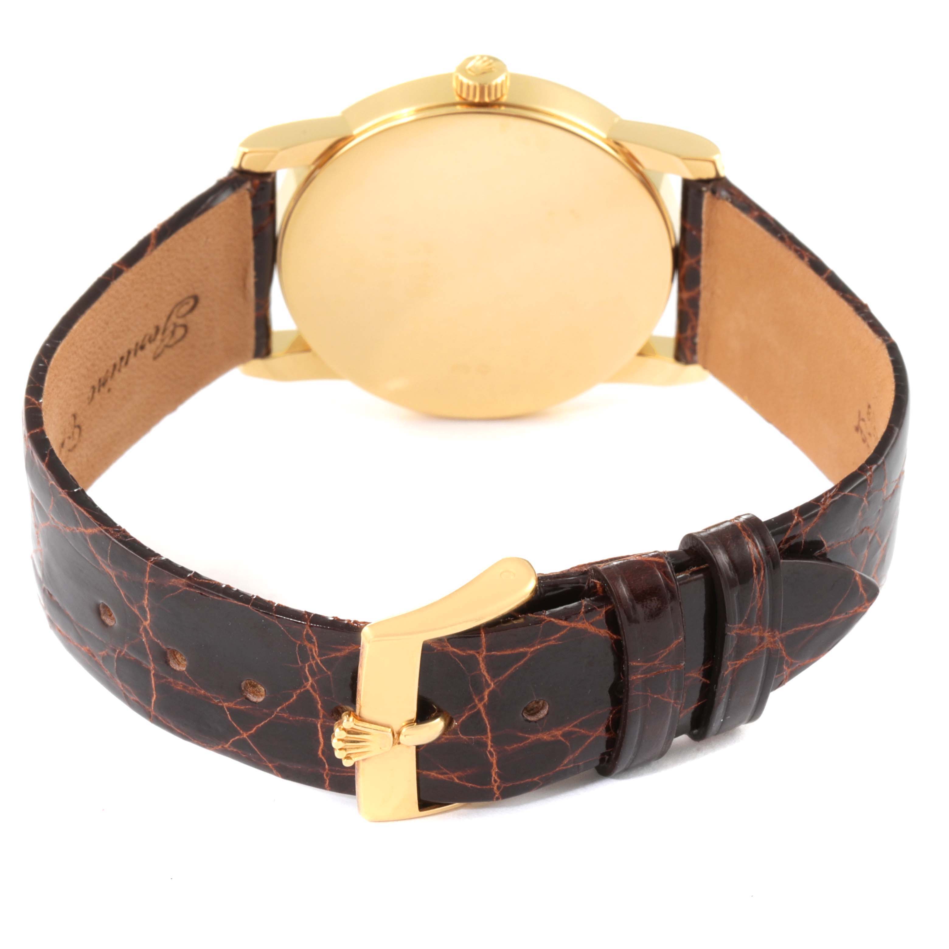 This image shows the back and strap of a Rolex Cellini 5116/8 Men's Yellow Gold Beige Dial 5116/8 Men's Yellow Gold Beige Dial watch with a brown leather band and gold buckle.