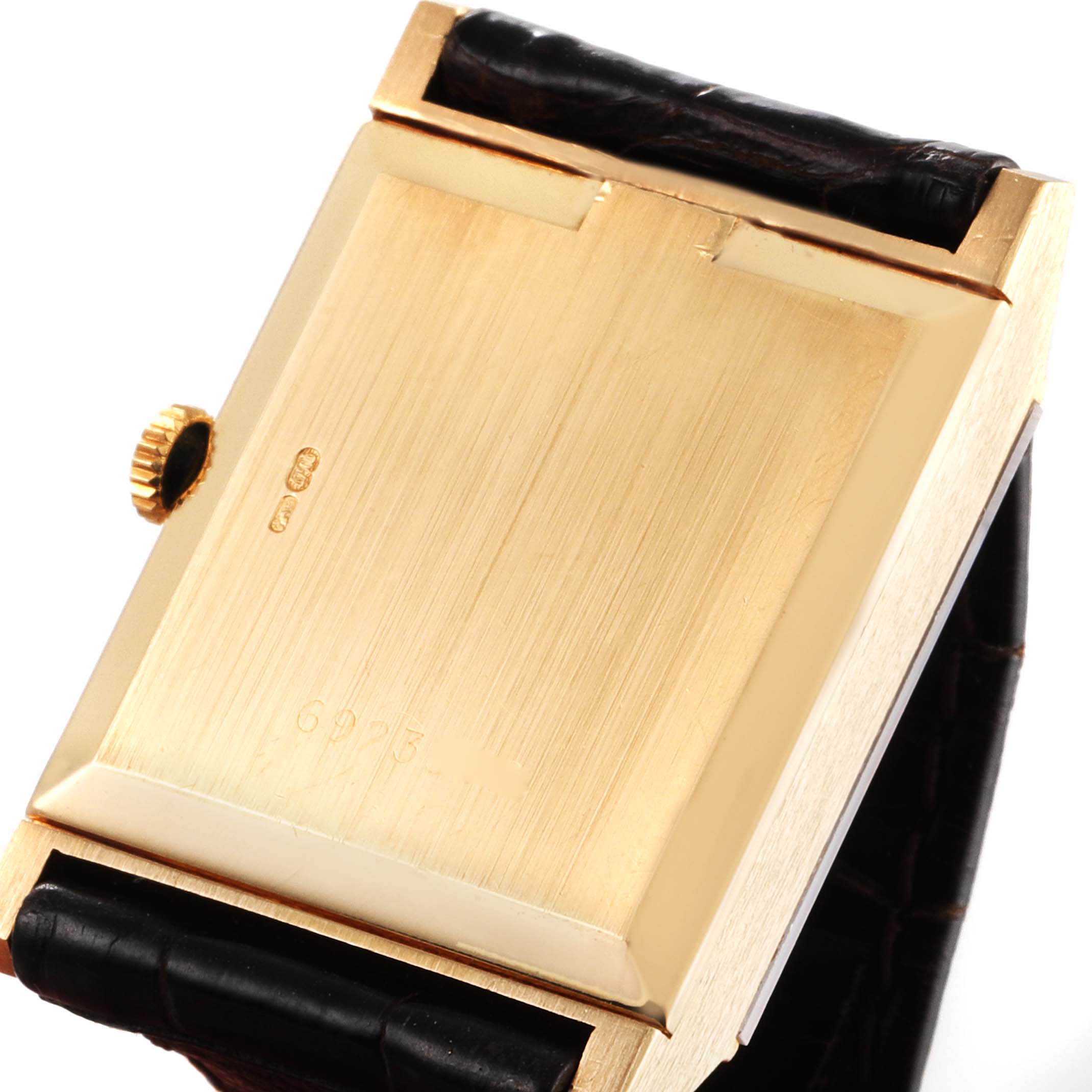This image shows the back view of the Rolex Cellini 4312 Men's Yellow Gold Champagne Dial 4312 Men's Yellow Gold Champagne Dial watch case and a portion of its leather strap.