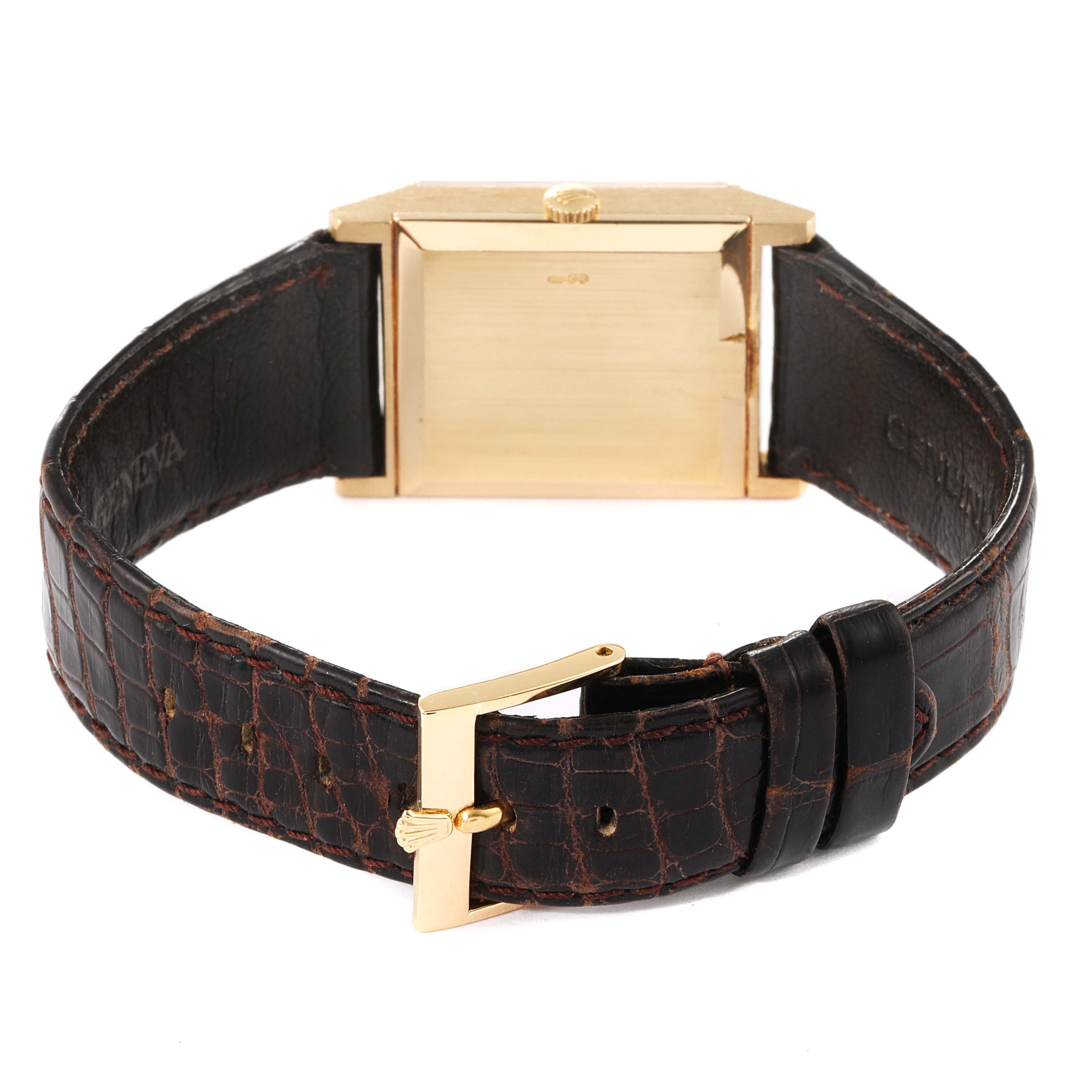 This image shows the rear side of a Rolex Cellini 4312 Men's Yellow Gold Champagne Dial 4312 Men's Yellow Gold Champagne Dial watch with a gold case and a brown leather strap.