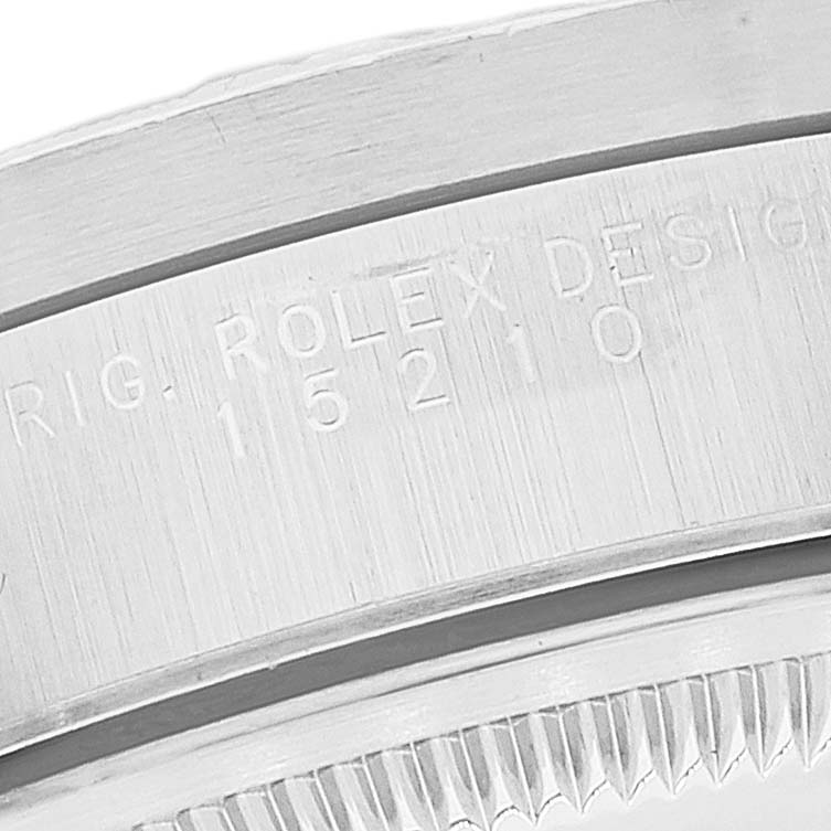 Close-up of the serial number and fluted bezel of a Rolex Date 15210 Men's Stainless Steel Black Dial 15210 Men's Stainless Steel Black Dial model watch.