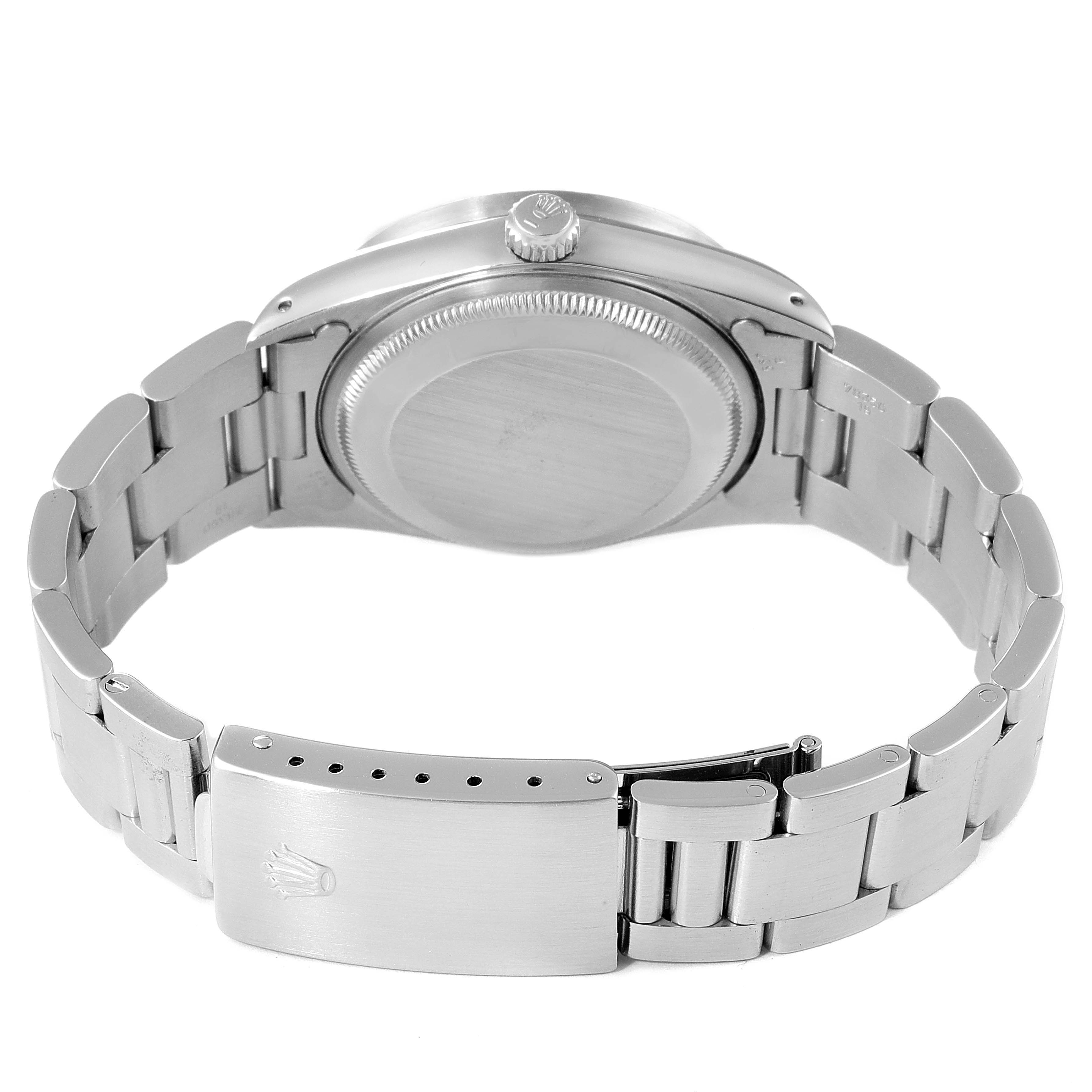 The image shows the back view of a Rolex Date 15210 Men's Stainless Steel Silver Dial 15210 Men's Stainless Steel Silver Dial model watch, focusing on the case back, crown, and metal bracelet with clasp.