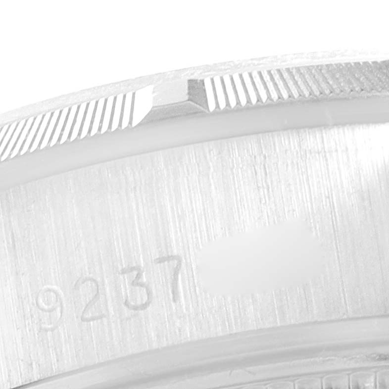 This close-up image shows the serial number engraving on the side of the bezel of a Rolex Date 69160 Women
s Stainless Steel White Dial 69160 Women
s Stainless Steel White Dial model watch.