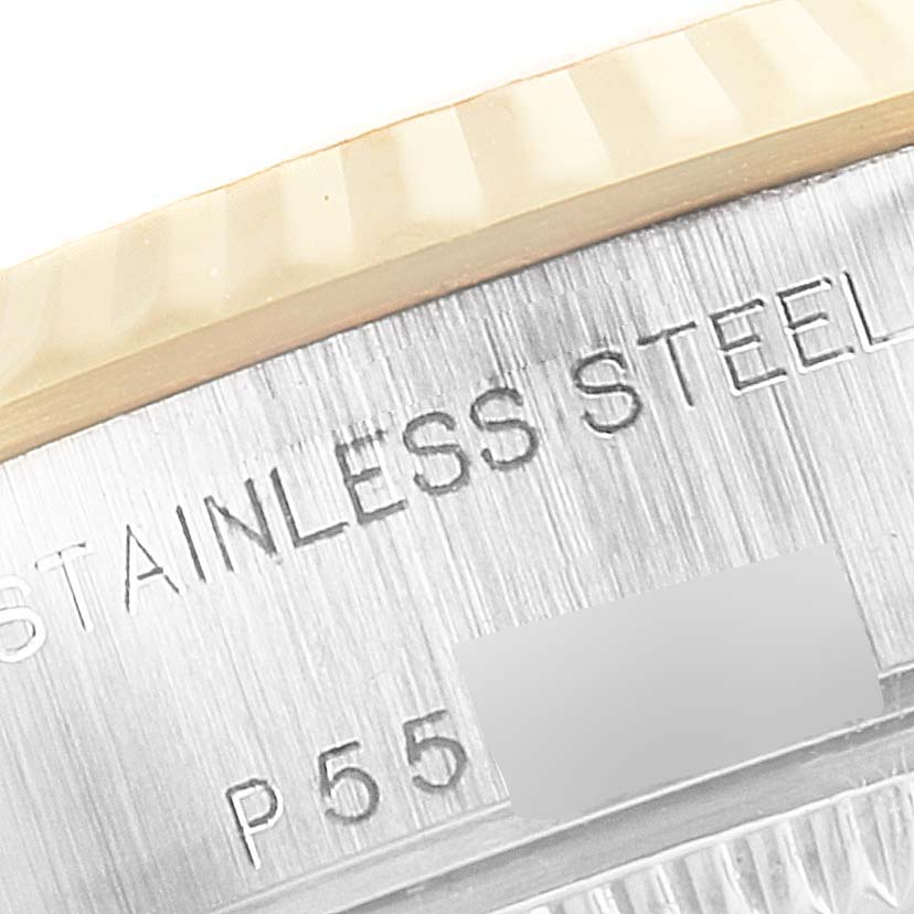 This close-up image shows the stainless steel side of the Rolex Datejust 79173 Women's Steel and Gold (two tone) Champagne Dial 79173 Women's Steel and Gold (two tone) Champagne Dial watch case, including part of the fluted bezel.