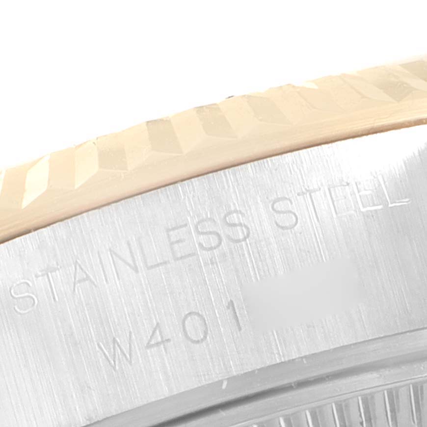 The image shows a close-up of the fluted bezel and engraved text on the stainless steel case of a Rolex Datejust 69173 Women's Steel and Gold (two tone) Champagne Dial 69173 Women's Steel and Gold (two tone) Champagne Dial watch.