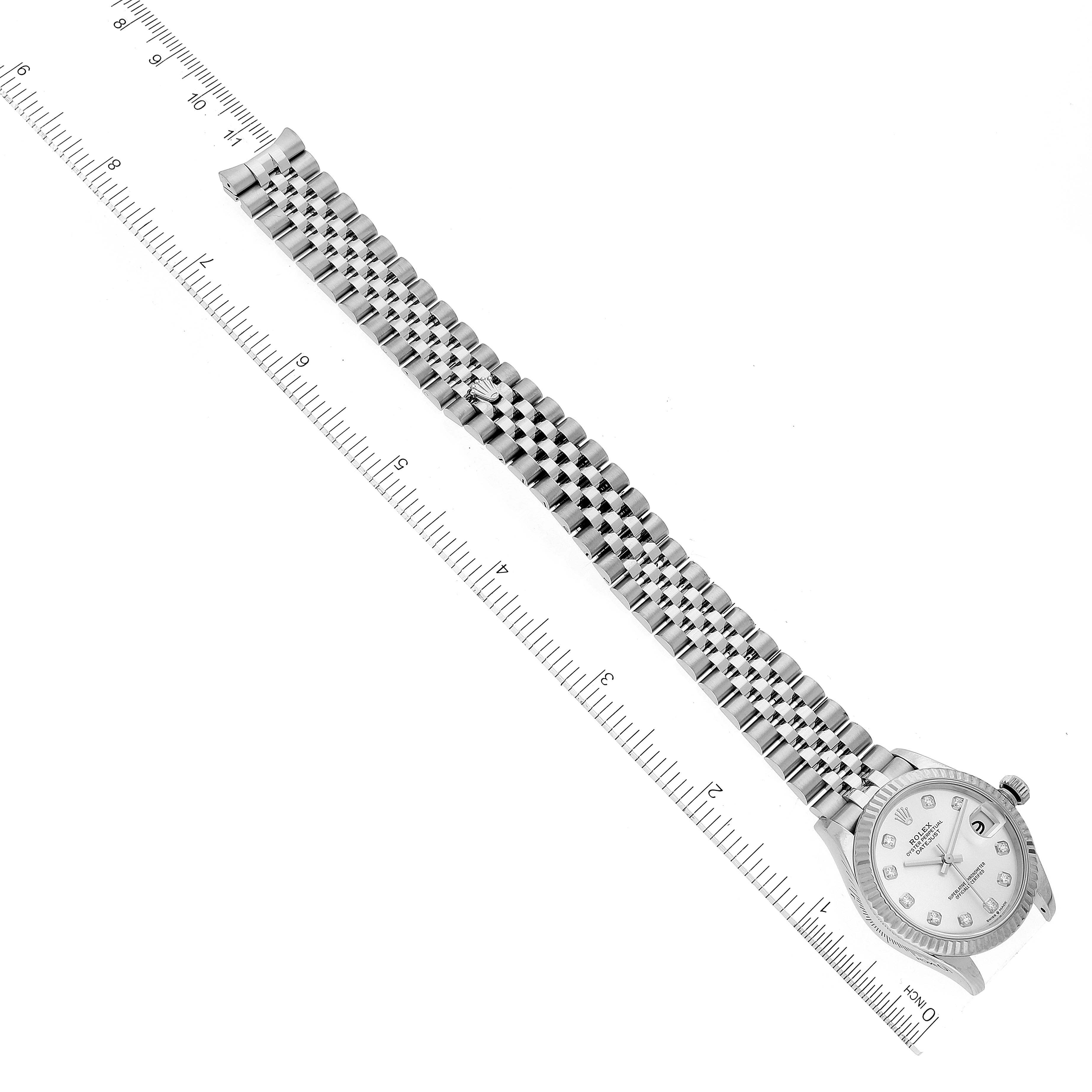 The image shows a Mid-Size Rolex watch laying flat with the bracelet and case in view, positioned alongside a ruler for measurement.