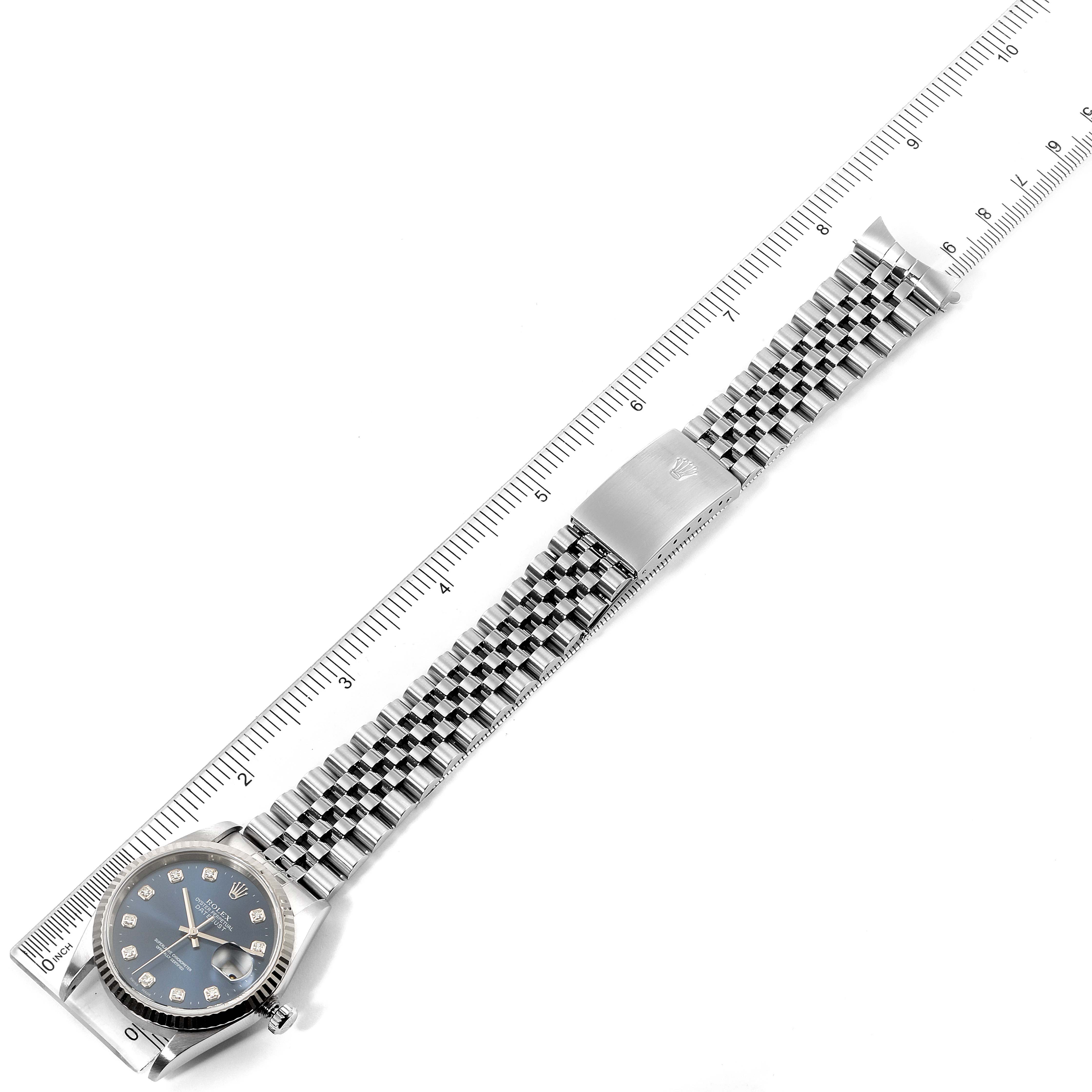 This top-down view of a Rolex Datejust 16234 Men's Stainless Steel Blue Dial 16234 Men's Stainless Steel Blue Dial watch shows the face, bracelet, and clasp against a ruler for scale.