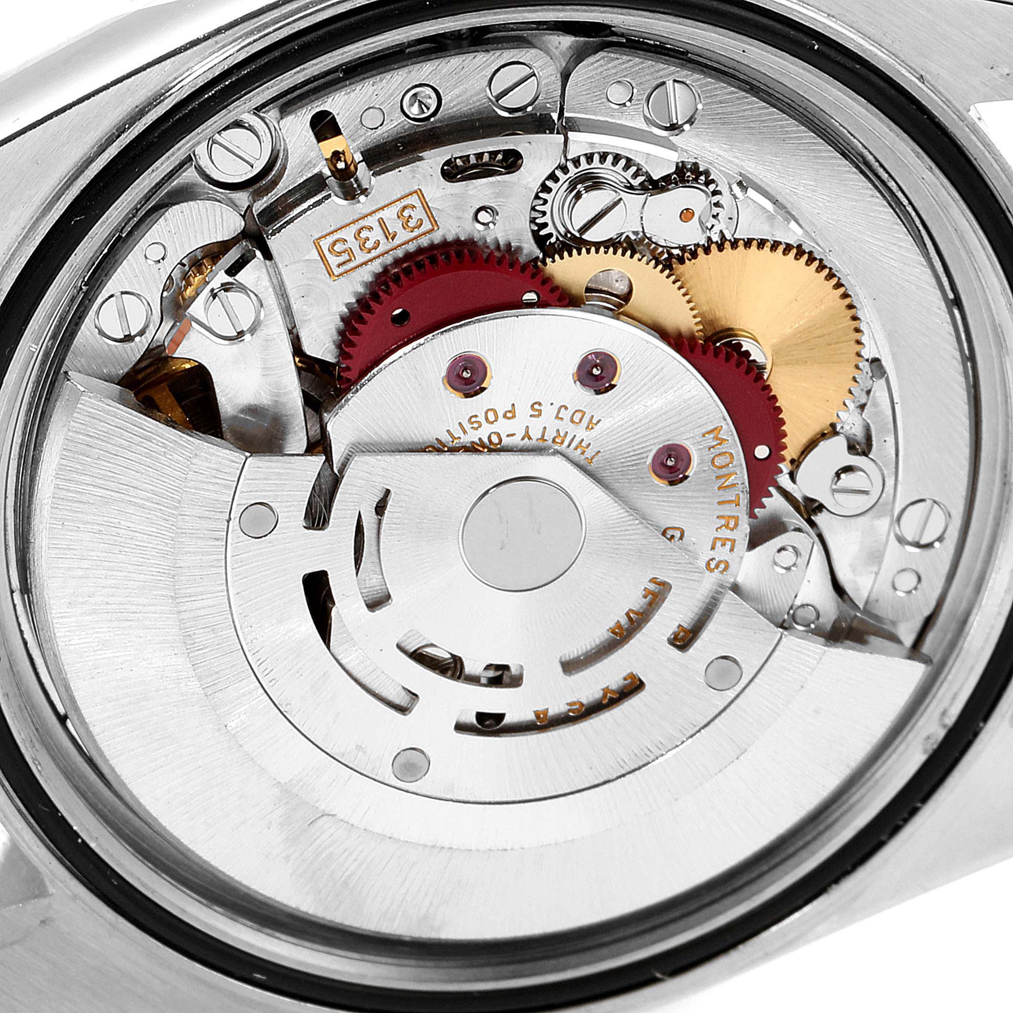 The image shows the internal mechanism of the Rolex Datejust 16234 Men's Stainless Steel Blue Dial 16234 Men's Stainless Steel Blue Dial watch, focusing on the movement parts like gears and cogs.