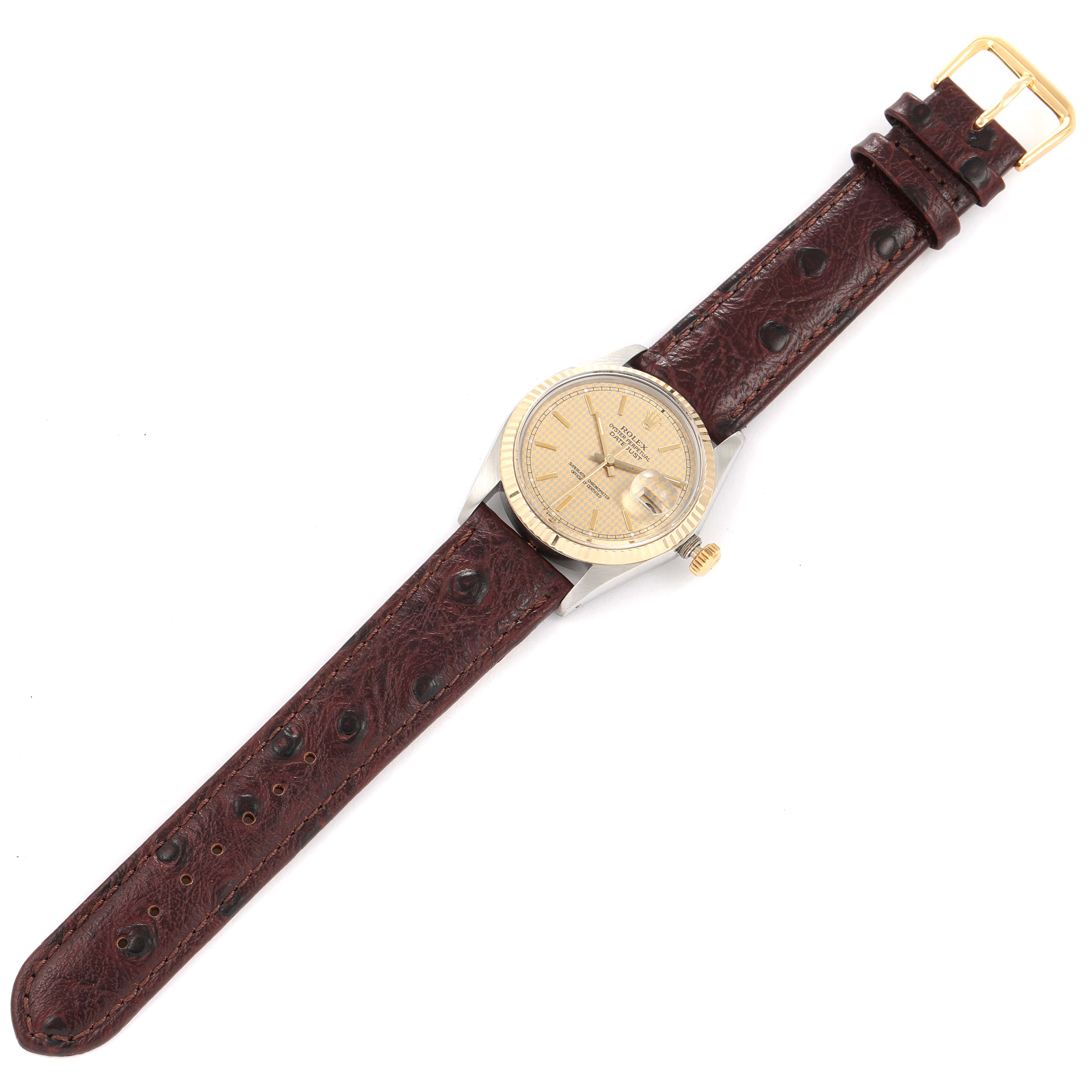 The image shows a top-down view of a Vintage Collection Rolex watch with a brown leather strap and a gold-tone face.