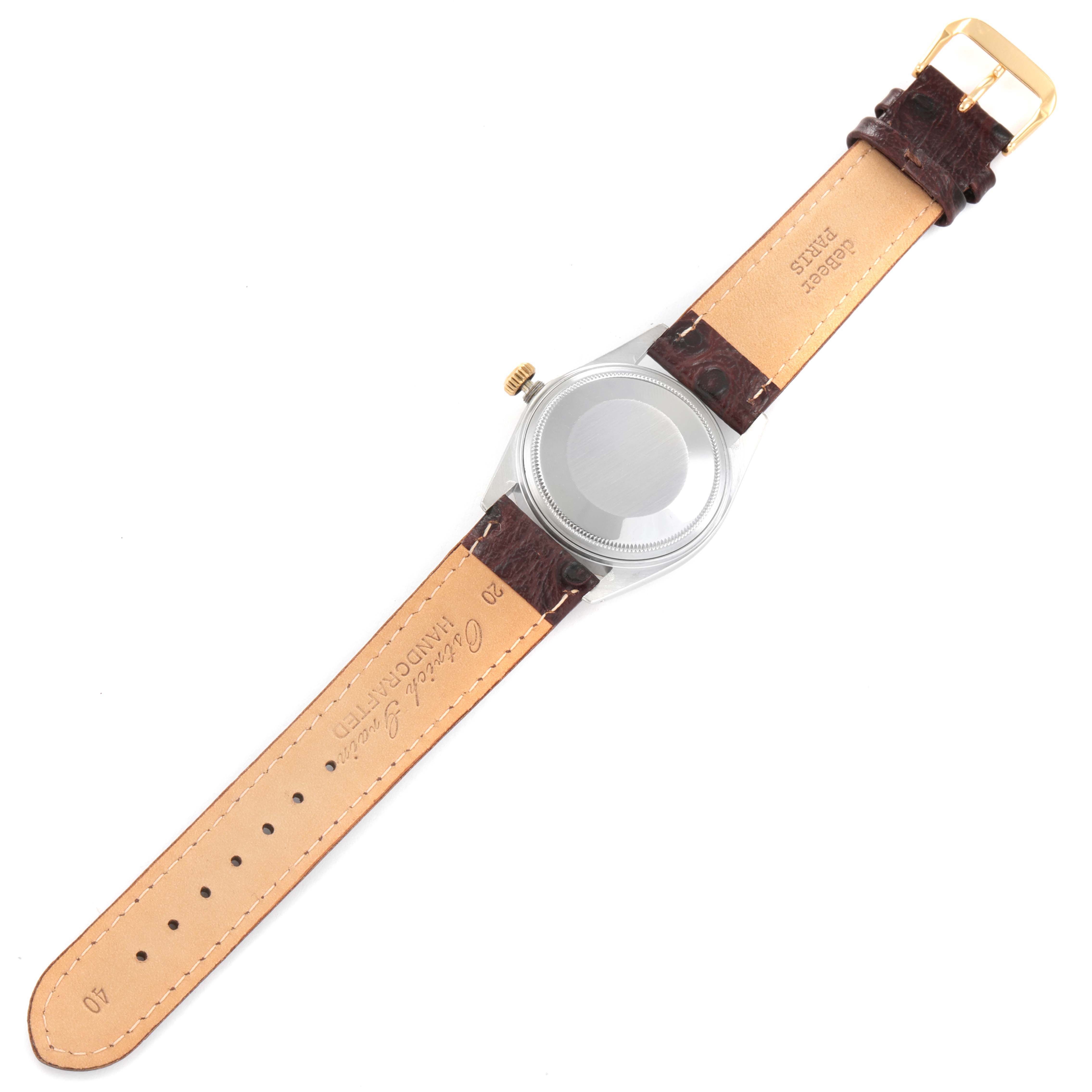 The image shows the back view of a Vintage Collection model by Rolex with its leather strap laid flat.