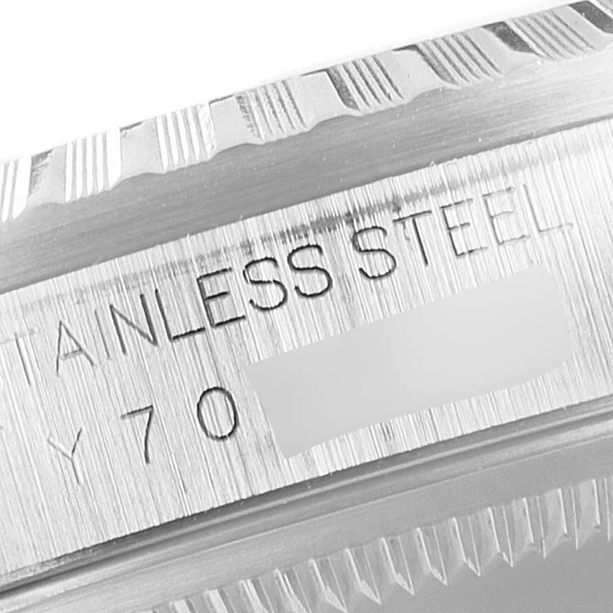 The image shows a close-up of the bezel and case side engraving of a Rolex Datejust 16220 Men's Stainless Steel Black Dial 16220 Men's Stainless Steel Black Dial watch, highlighting the stainless steel text.