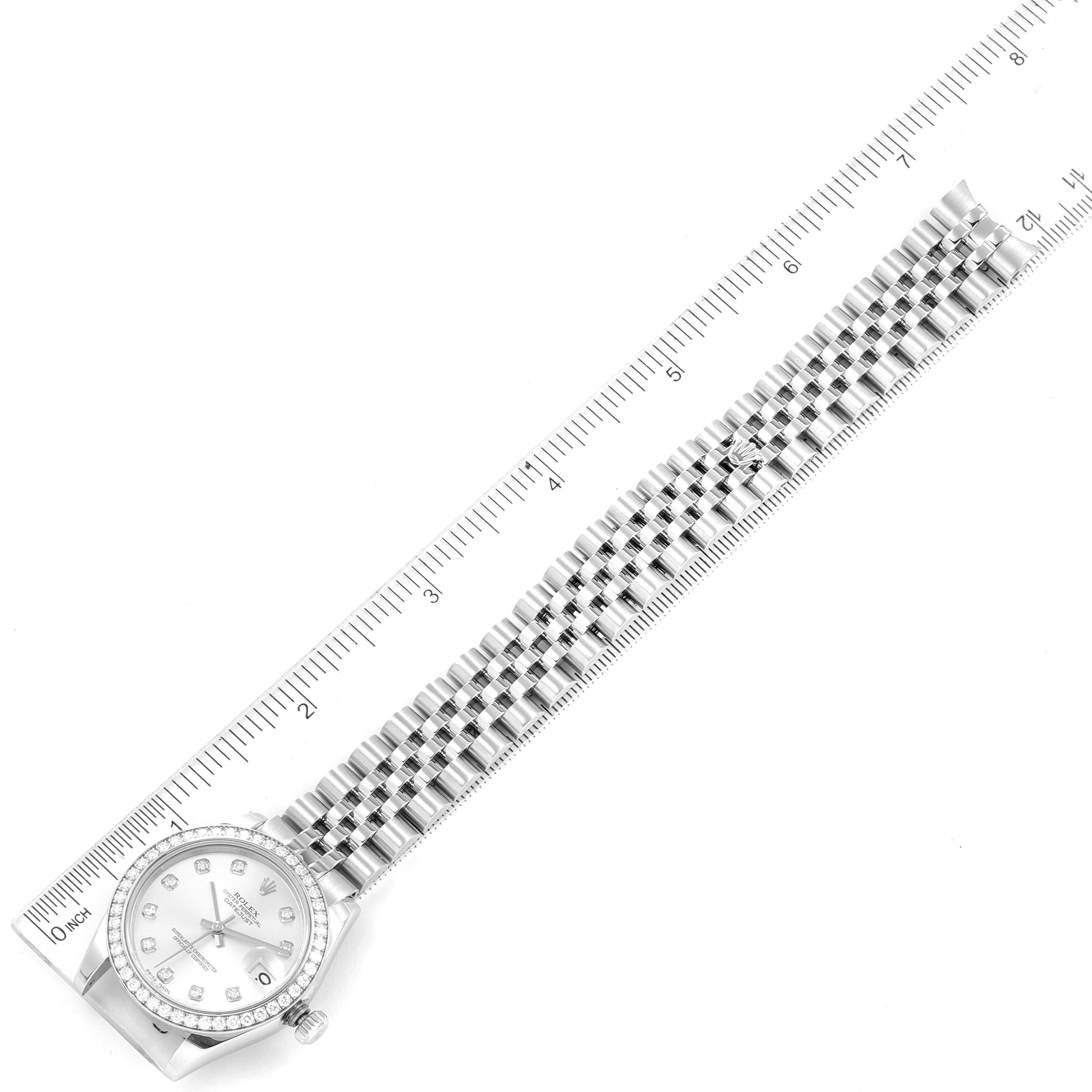 This image shows a top-down view of a Rolex Mid-Size 178384 Women's Stainless Steel Silver Dial 178384 Women's Stainless Steel Silver Dial watch, including the dial, bezel, and bracelet, alongside a ruler for scale.