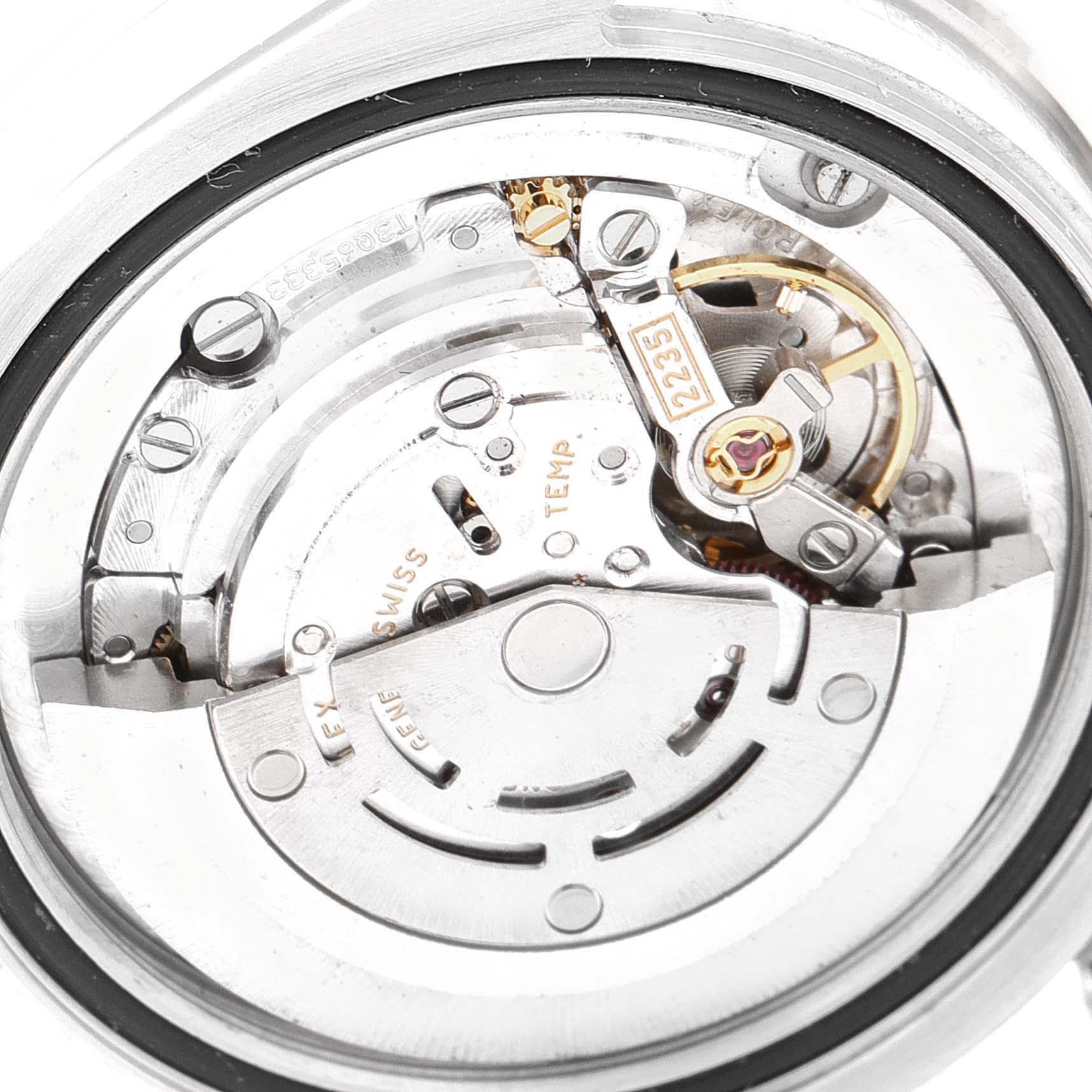 The image shows the intricate inner mechanism and movement of the Mid-Size Rolex watch from a close-up underside angle.