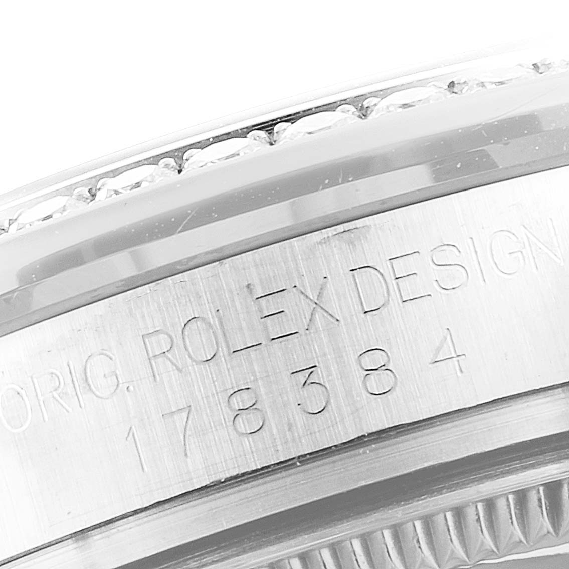 This close-up image shows the side of a bezel and the engraved model number on the casing of a Rolex Mid-Size 178384 Women's Stainless Steel Silver Dial 178384 Women's Stainless Steel Silver Dial watch.