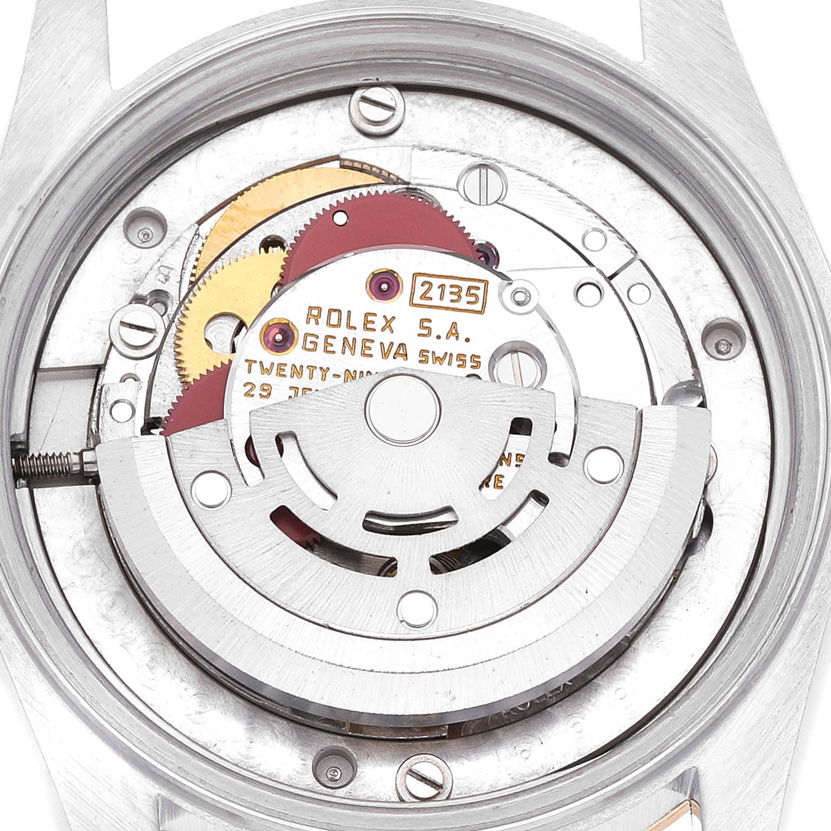 The image shows the inner mechanical movement of a Mid-Size Rolex watch viewed from the back, displaying gears and the Rolex imprint.