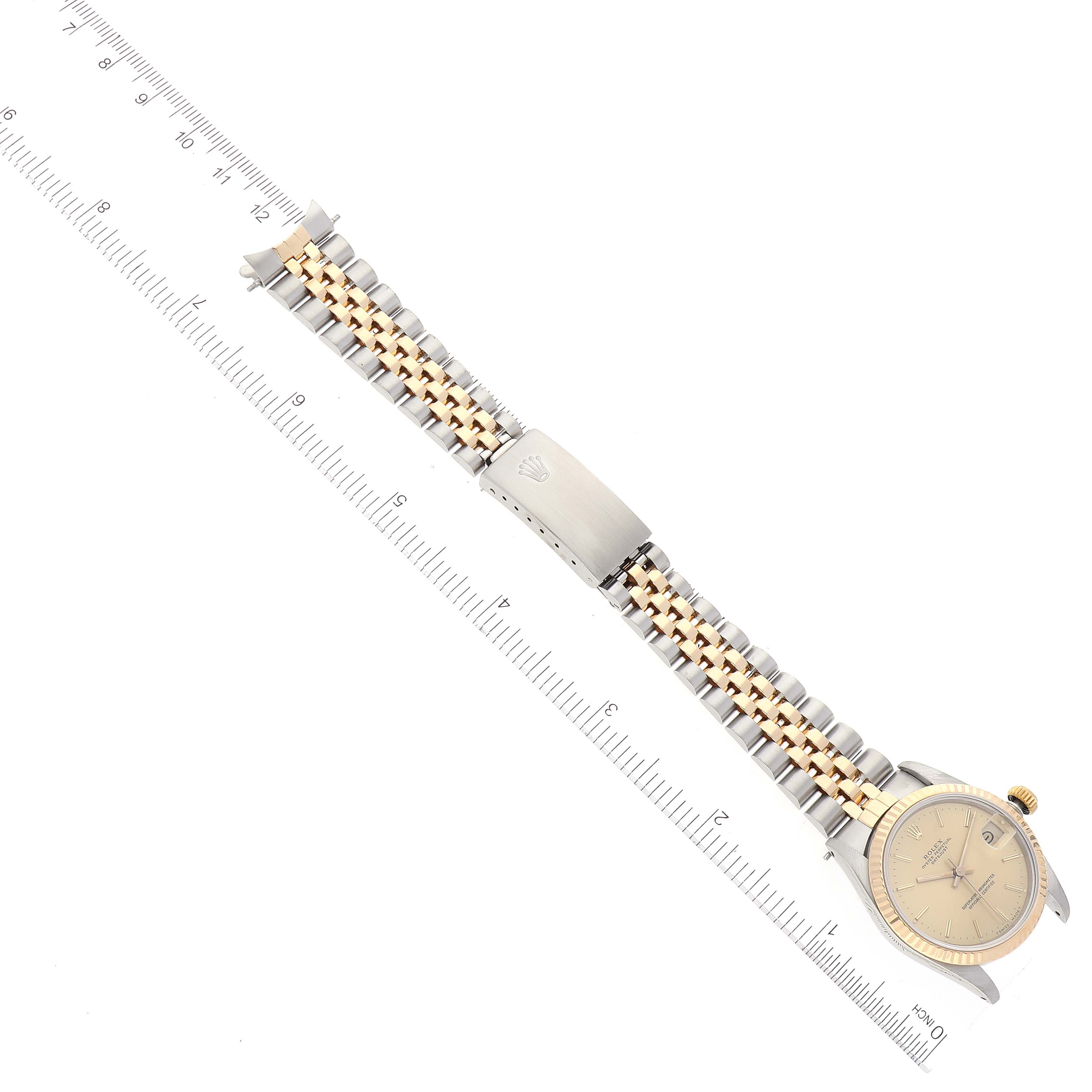 This image shows a Rolex Mid-Size 68273 Women's Steel and Gold (two tone) Champagne Dial 68273 Women's Steel and Gold (two tone) Champagne Dial model watch from a top-down angle, displaying its face, bracelet, and clasp.