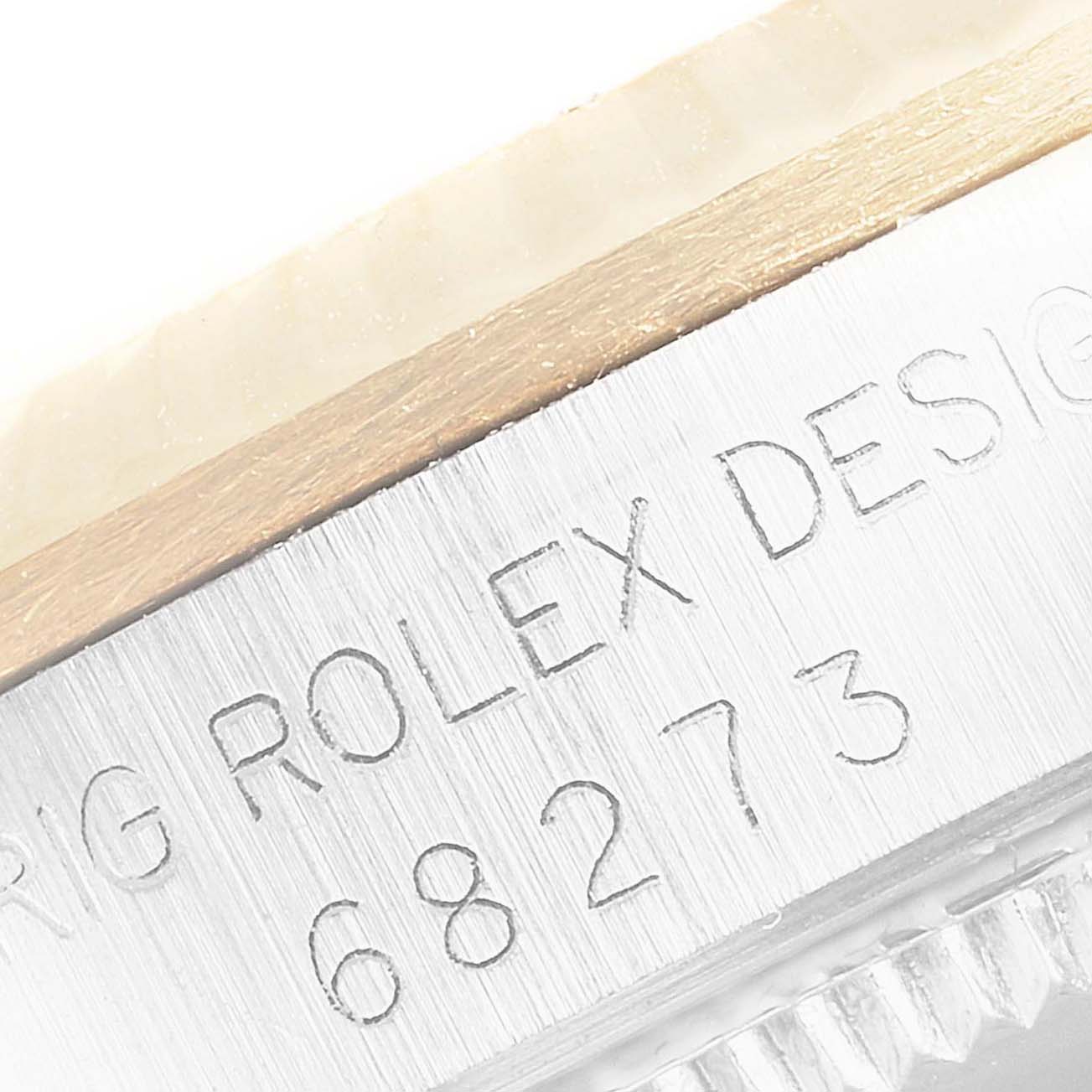 This close-up shows the engraved side of a Mid-Size Rolex watch's case, including the model number "68273."
