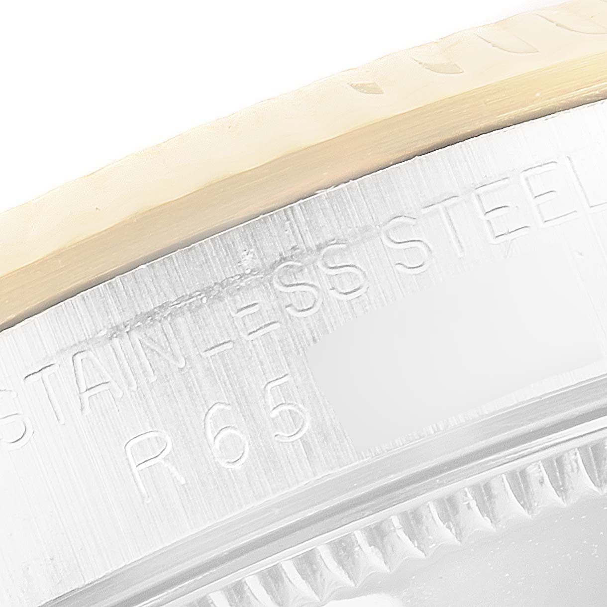 The image shows a close-up view of the stainless steel case of a Rolex Mid-Size 68273 Women's Steel and Gold (two tone) Champagne Dial 68273 Women's Steel and Gold (two tone) Champagne Dial model, focusing on the engraved text.