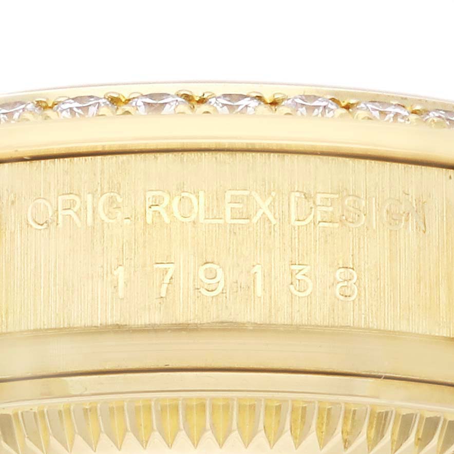 The image shows a close-up side view of the Rolex President 179138 Women's Yellow Gold Champagne Dial 179138 Women's Yellow Gold Champagne Dial watch model, focusing on its engraved bezel area with diamonds.