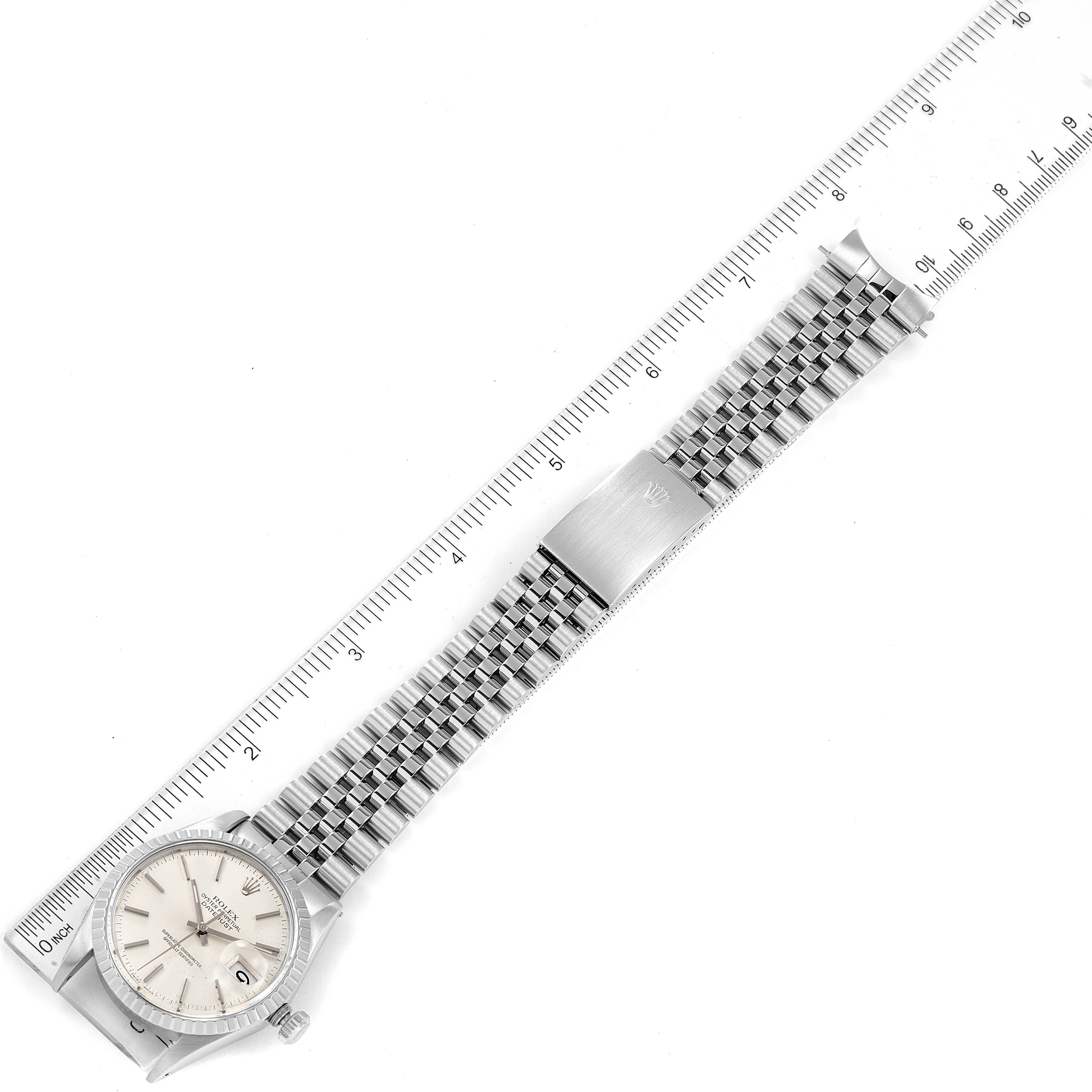 This image shows an overhead view of the Vintage Collection Rolex watch, displaying its face, bracelet, and clasp alongside a ruler.