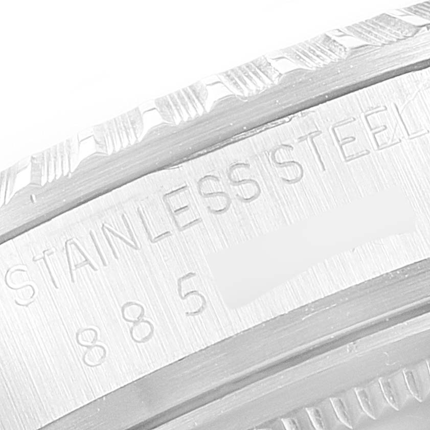 This close-up image shows the stainless steel engraved casing of a Rolex Vintage Collection 16030 Men's Stainless Steel Silver Dial 16030 Men's Stainless Steel Silver Dial watch.