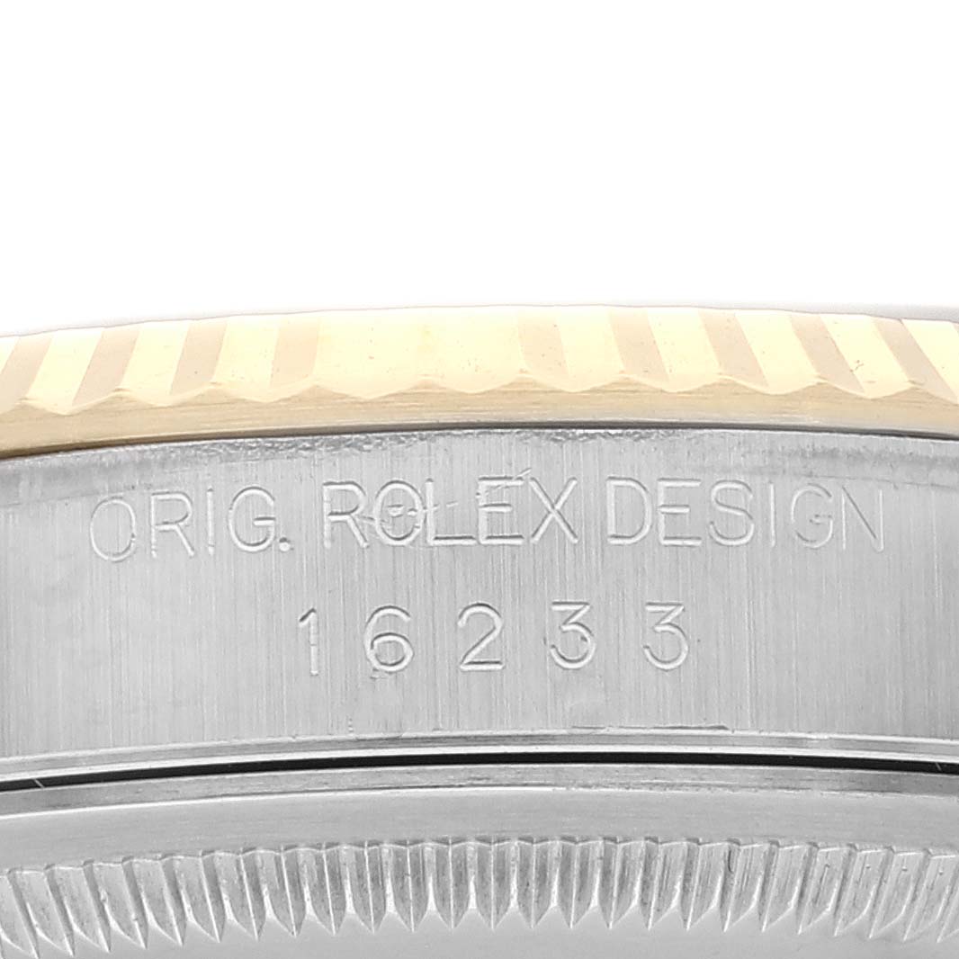 The image shows a close-up angle of a Rolex Datejust 16233 Men's Steel and Gold (two tone) White Dial 16233 Men's Steel and Gold (two tone) White Dial model 16233 case, highlighting the engraved "ORIG. ROLEX DESIGN" text.