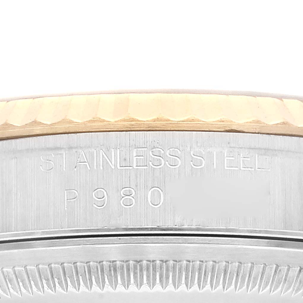 This close-up image of the Rolex Datejust 16233 Men's Steel and Gold (two tone) White Dial 16233 Men's Steel and Gold (two tone) White Dial watch model shows the stainless steel case with some text engraving.