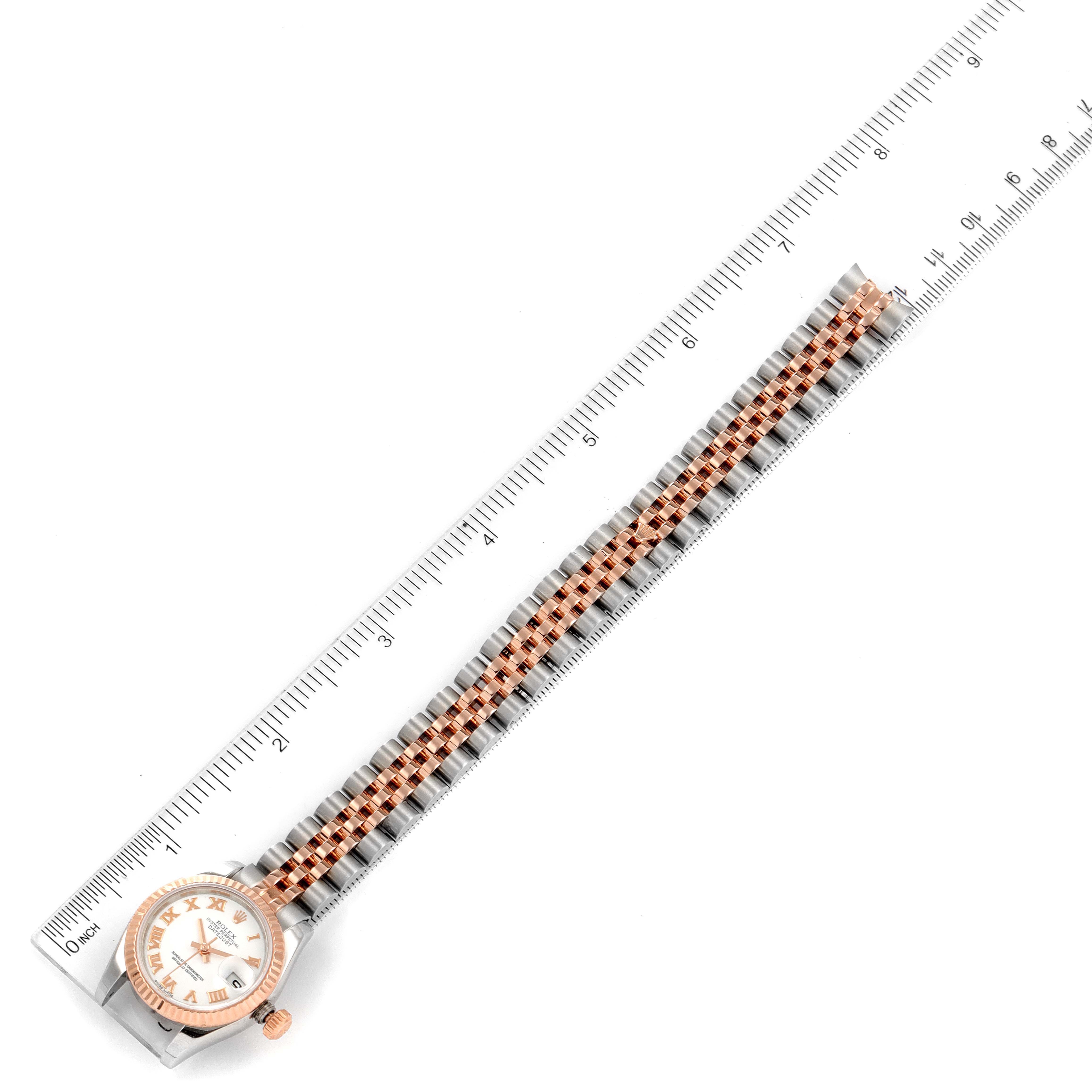 The image shows a Rolex Datejust 179171 Women's Steel and Gold (two tone) White Dial 179171 Women's Steel and Gold (two tone) White Dial watch with a ruler, capturing the watch face and entire bracelet from above.