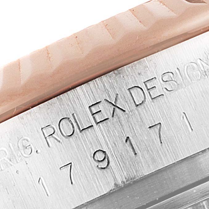 The image shows a close-up view of the Rolex Datejust 179171 Women's Steel and Gold (two tone) White Dial 179171 Women's Steel and Gold (two tone) White Dial design number and part of the bezel.