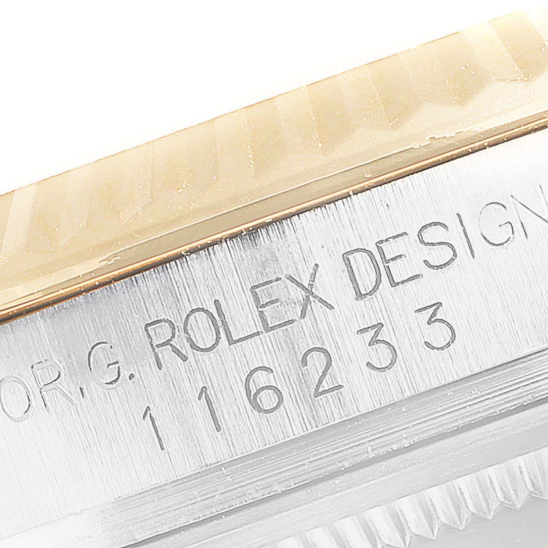 This image shows a close-up of the model number engraving on the side of a Rolex Datejust 116233 Men's Steel and Gold (two tone) Black Dial 116233 Men's Steel and Gold (two tone) Black Dial watch case.