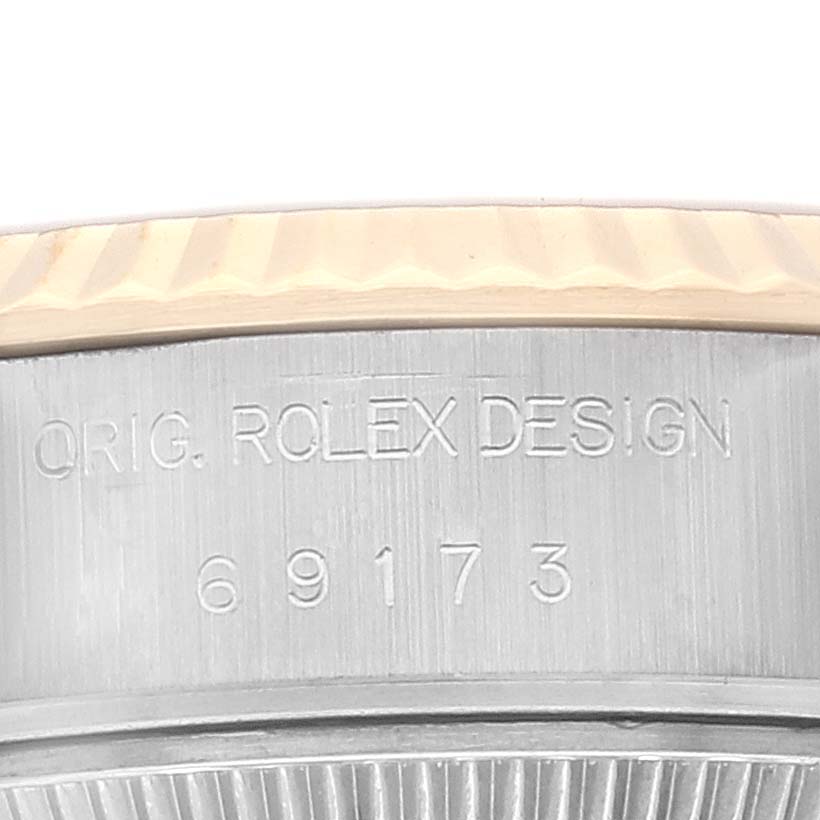 The image shows a close-up of the Datejust model by Rolex's case, focusing on the engraved model number 69173 and "ORIG. ROLEX DESIGN".
